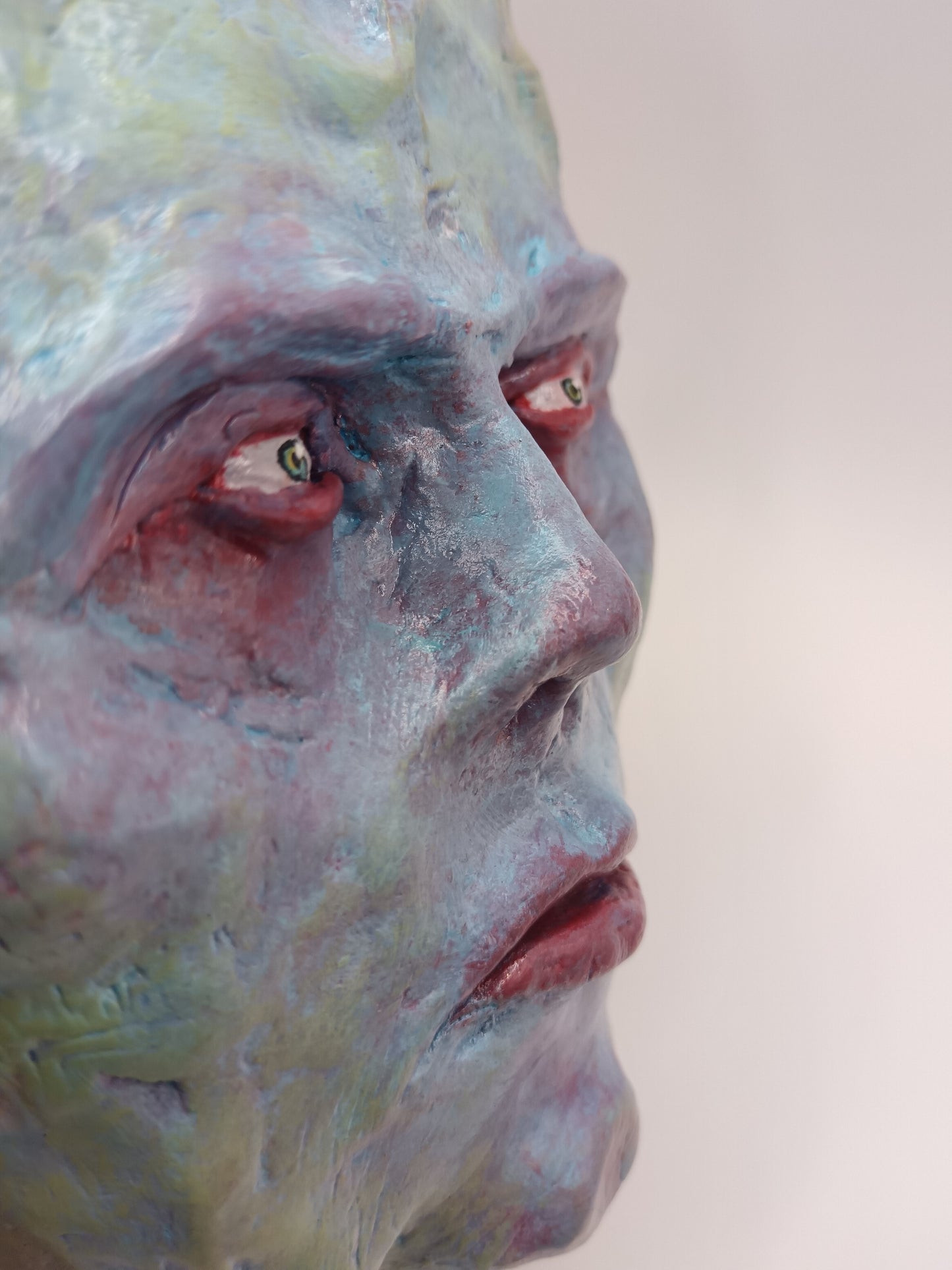 Hand sculpted clay pastel demon sculpture close up