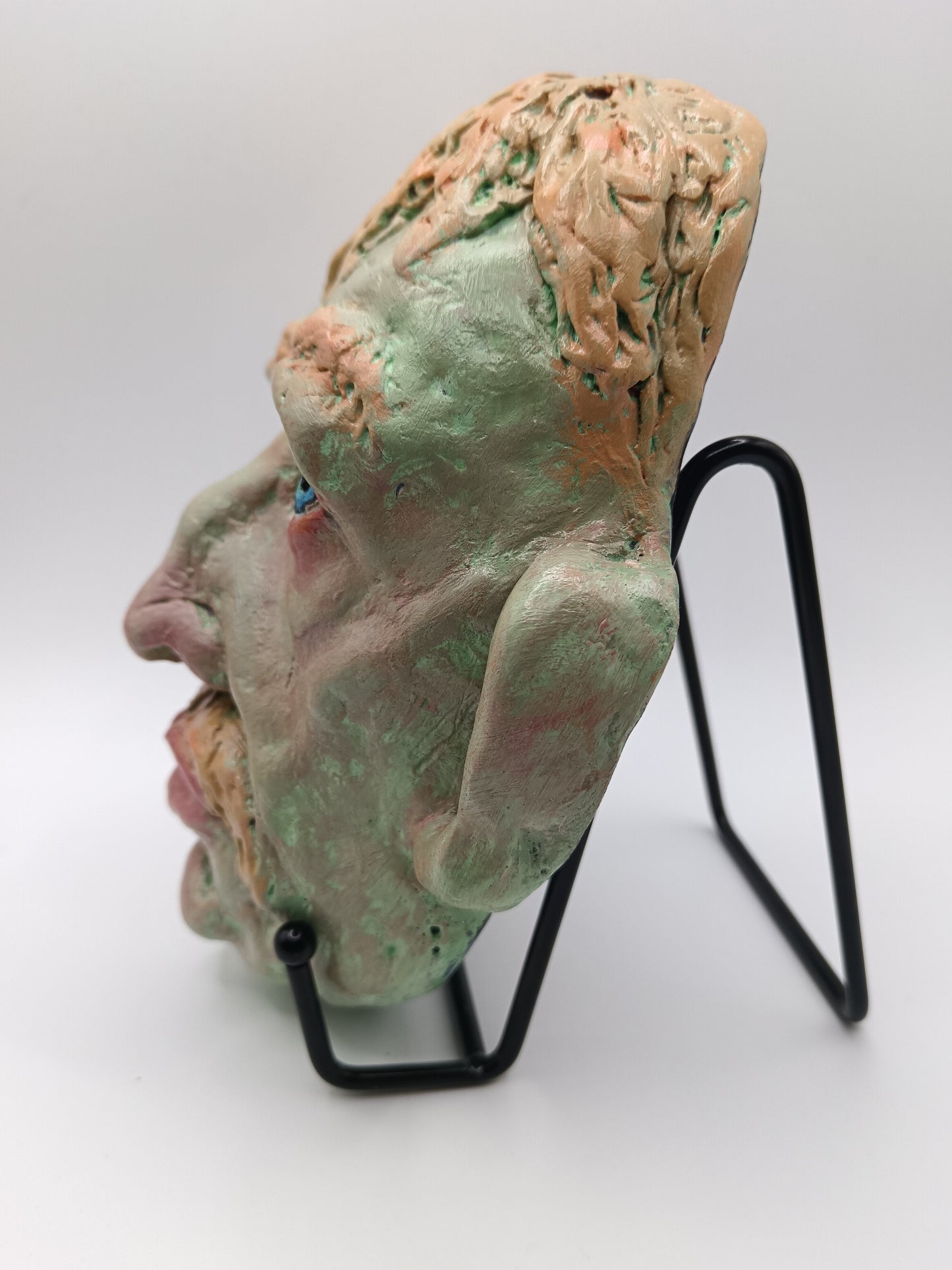 Hand sculpted green man sculpture with stand, left side