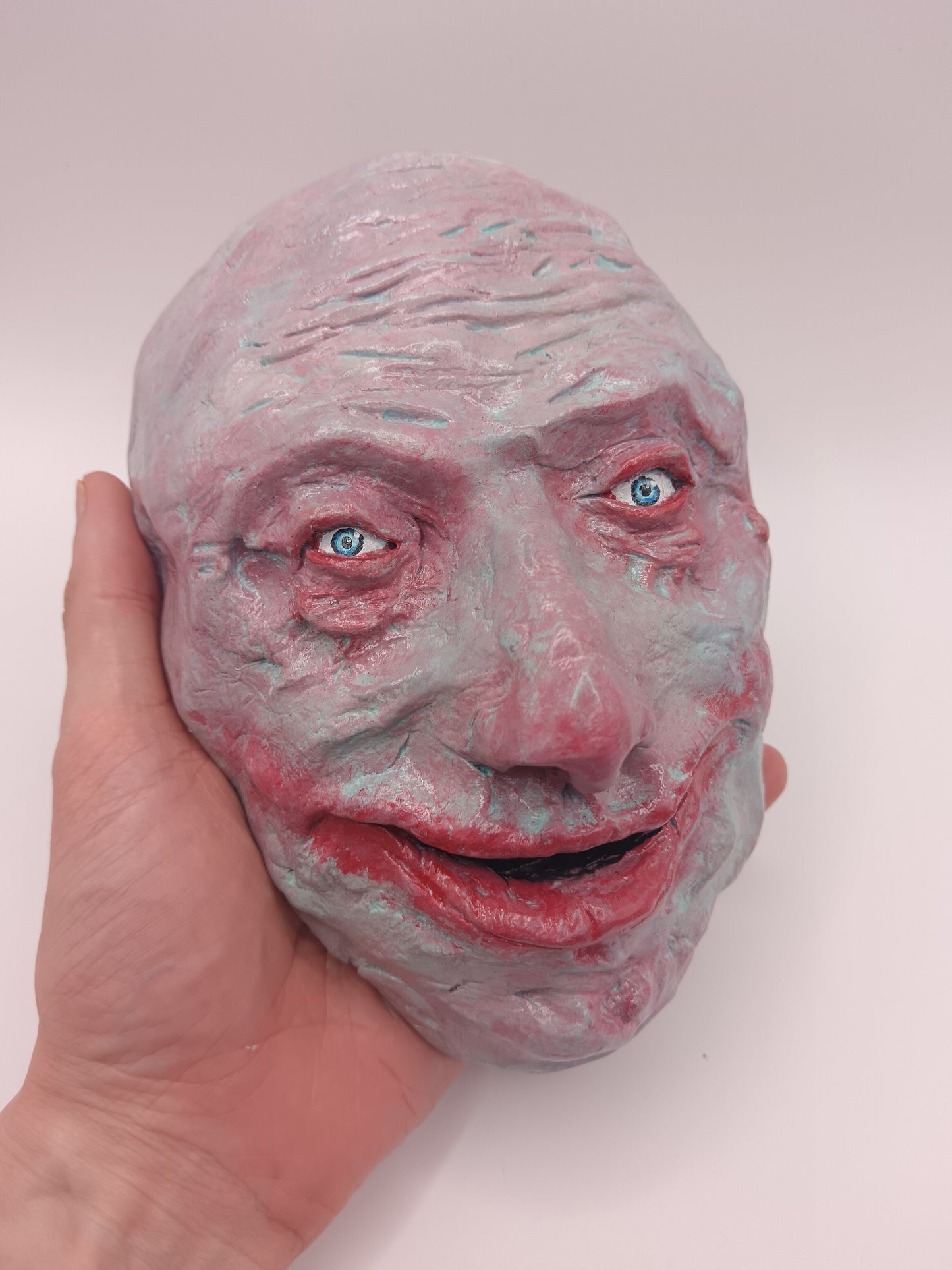 creepy grinning hand sculptured horror sculpture