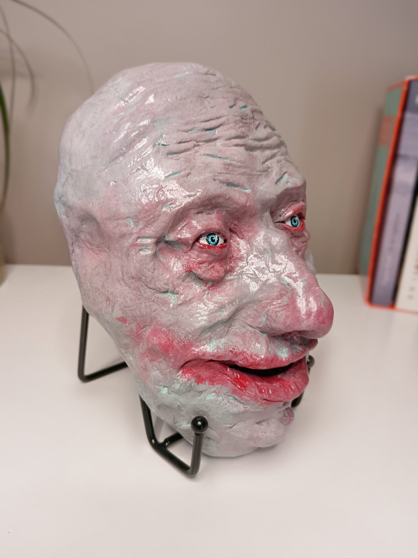 creepy grinning hand sculptured horror sculpture side view