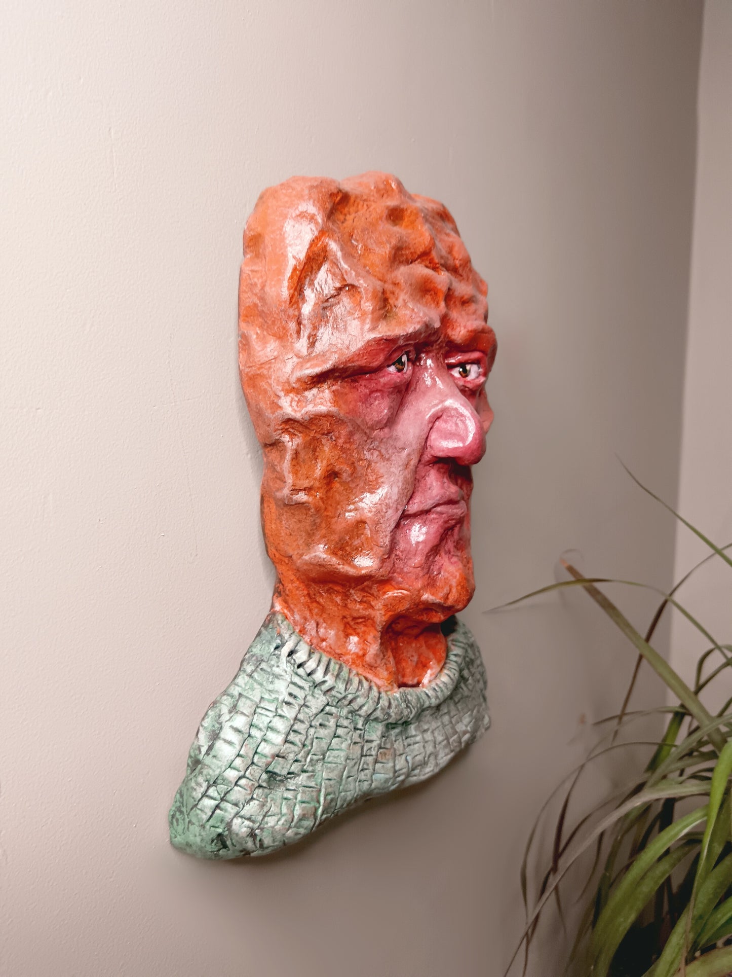 hand sculpted clay alien art, wall mounted side