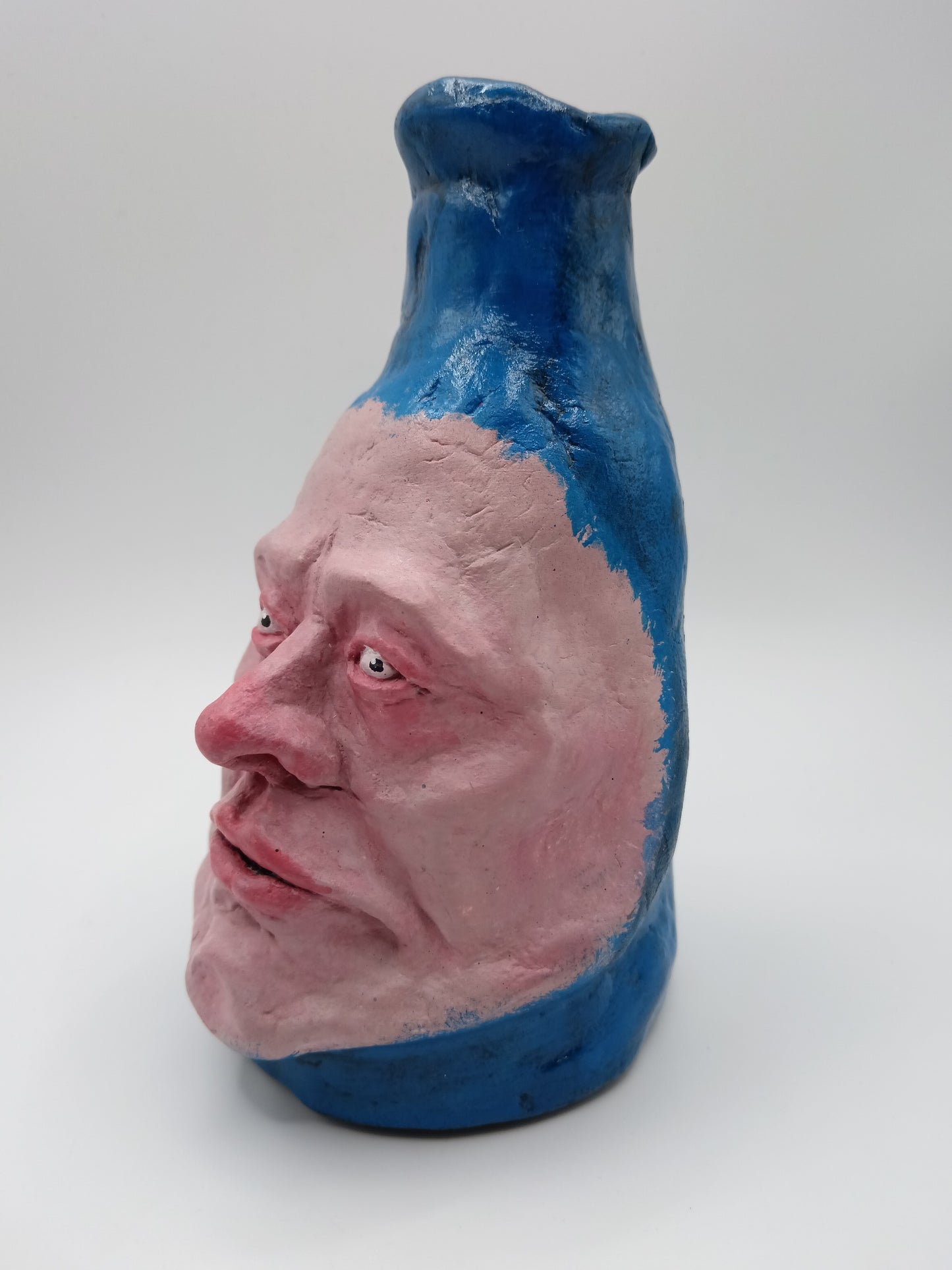 Hand sculpted blue face Vase -left view