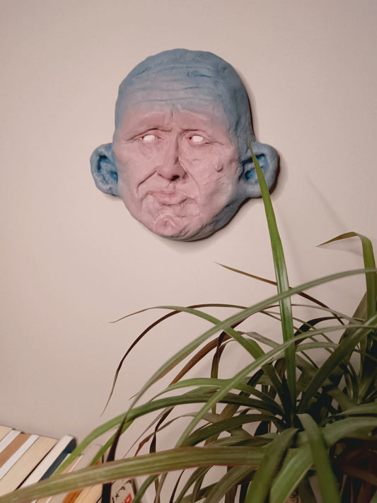 Wall-mounted blue mask sculpture wall mounted