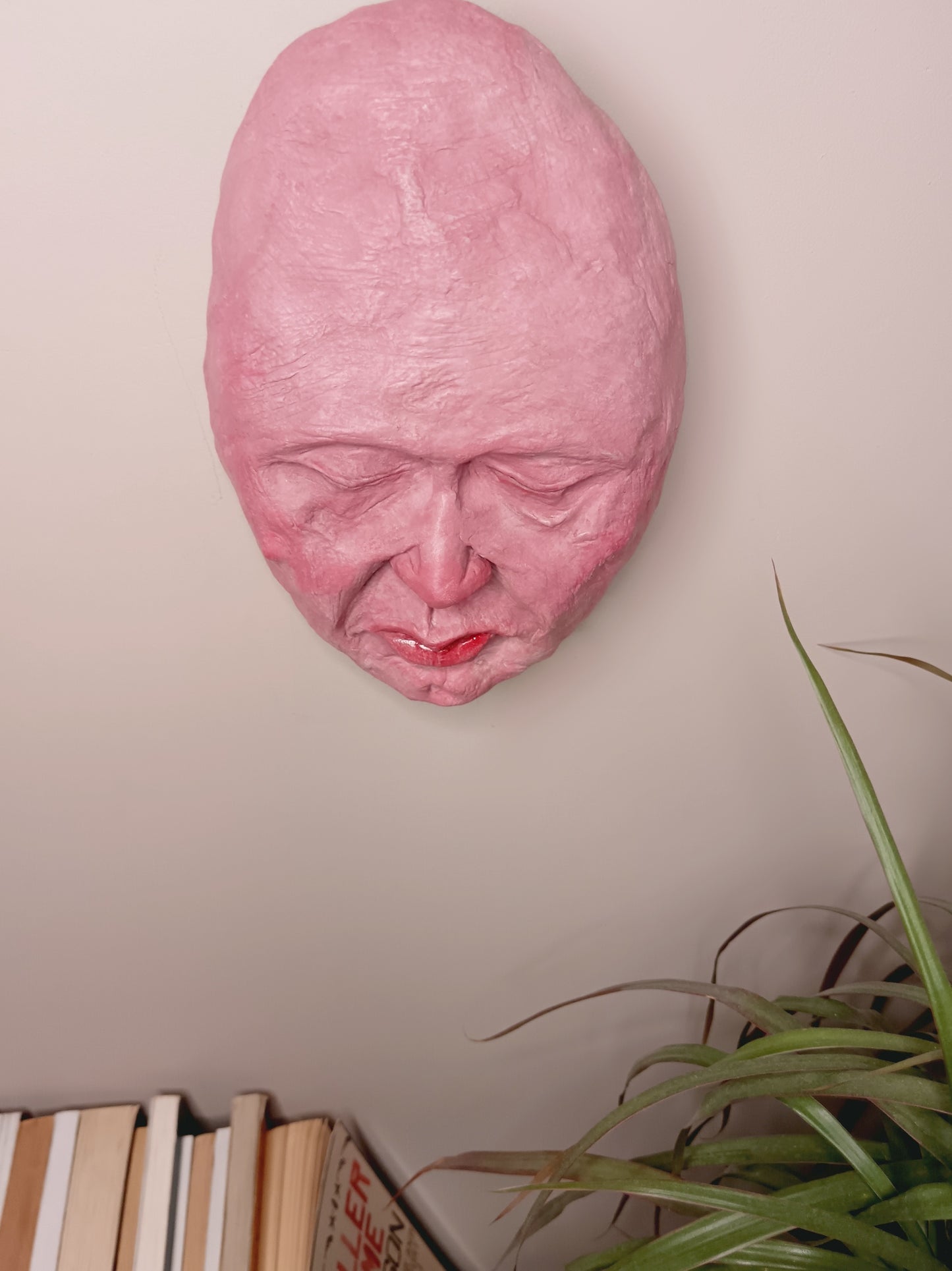 hand sculpted egghead sculpture, wall mounted top view