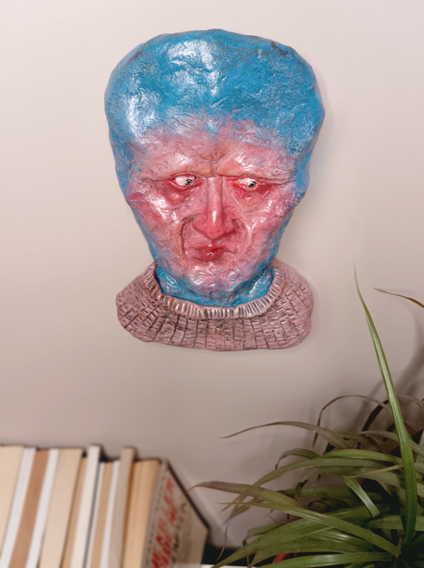 handmade clay alien sculpture, wall mounted top view