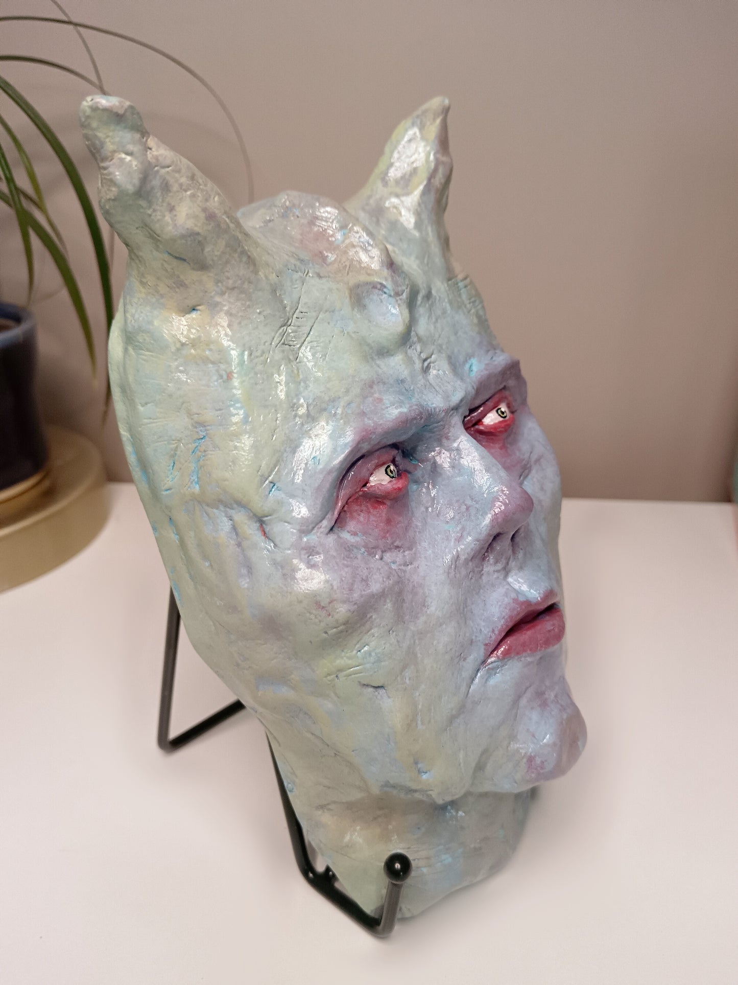 Hand sculpted clay pastel demon sculpture side