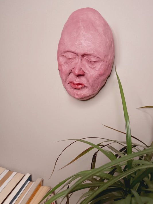 hand sculpted egghead sculpture, home setting, Wall mounted