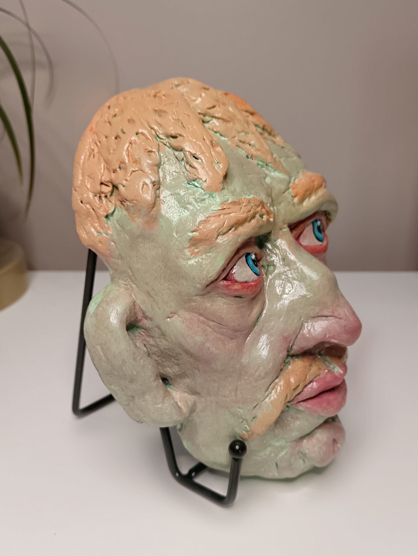 Hand sculpted green man sculpture side view