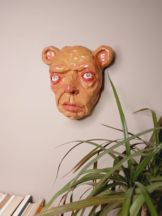 creepy yellow bear, hand sculpted clay sculpture mask wall art