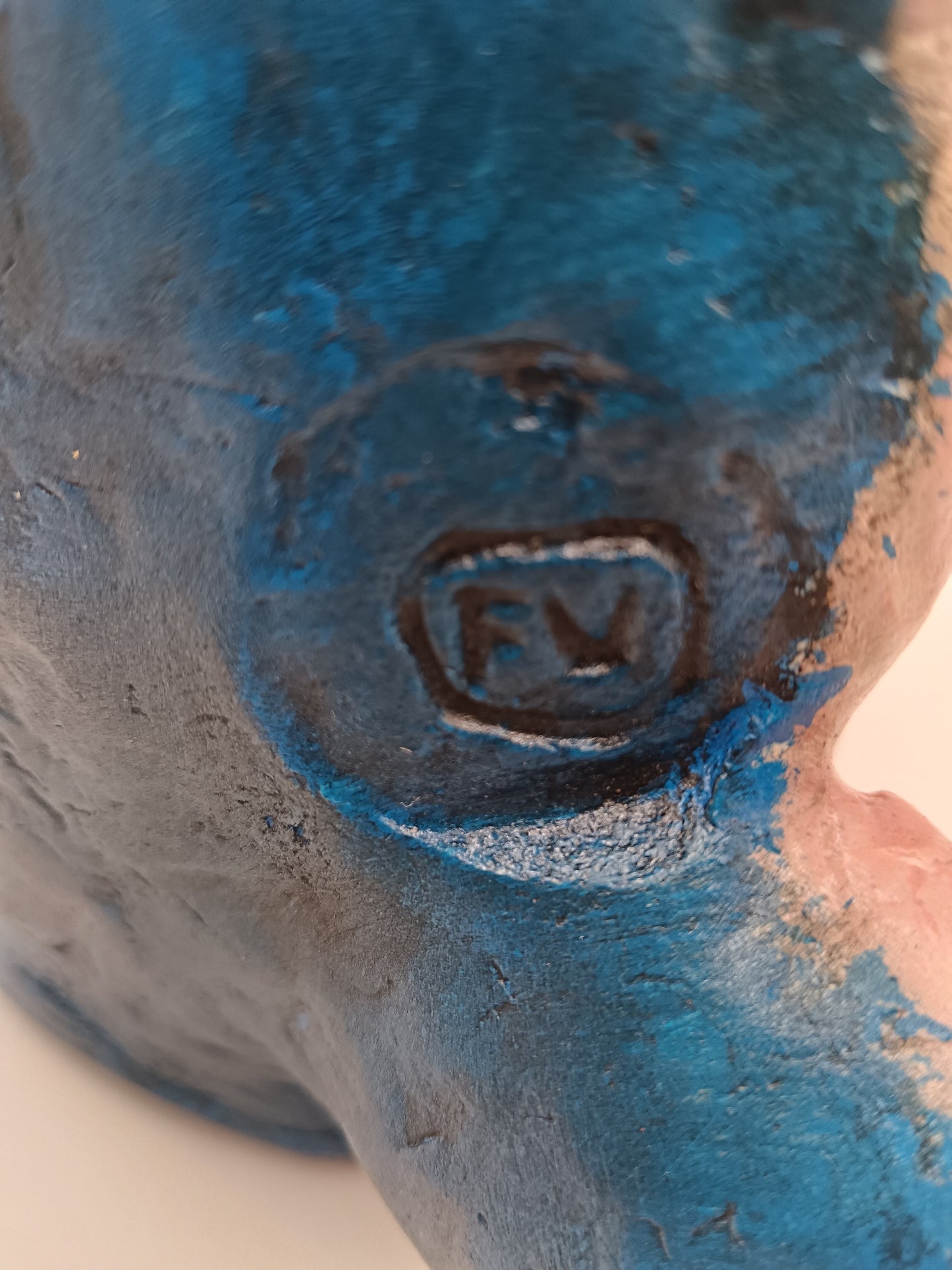 Close-up of a signature on a textured blue surface