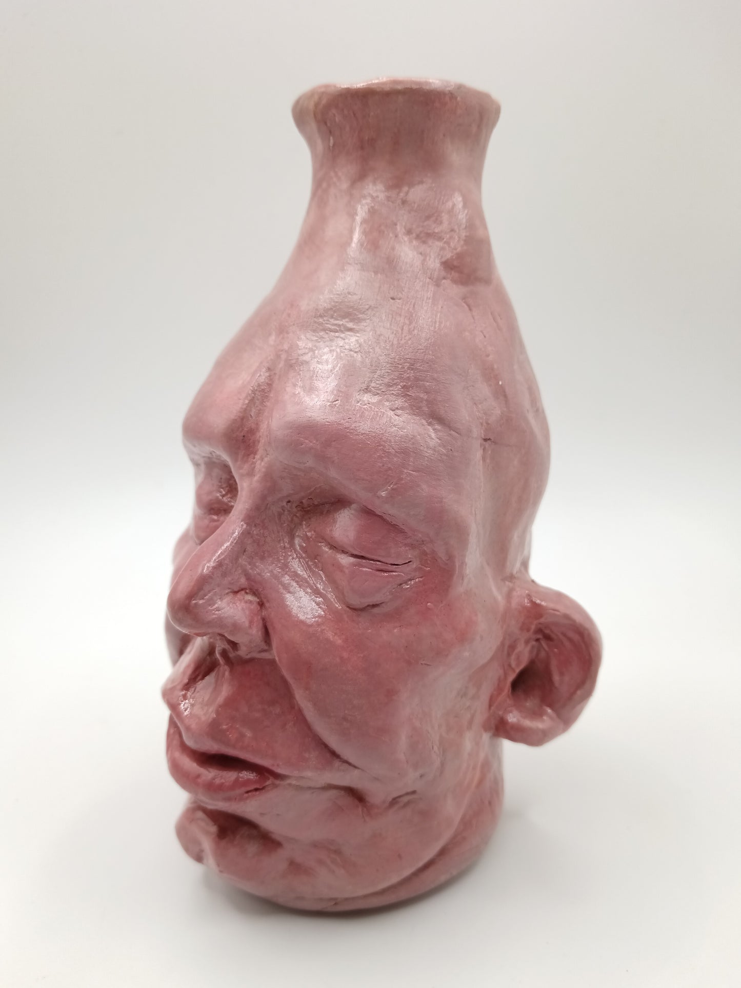 handmade closed-eye clay face vase, left view