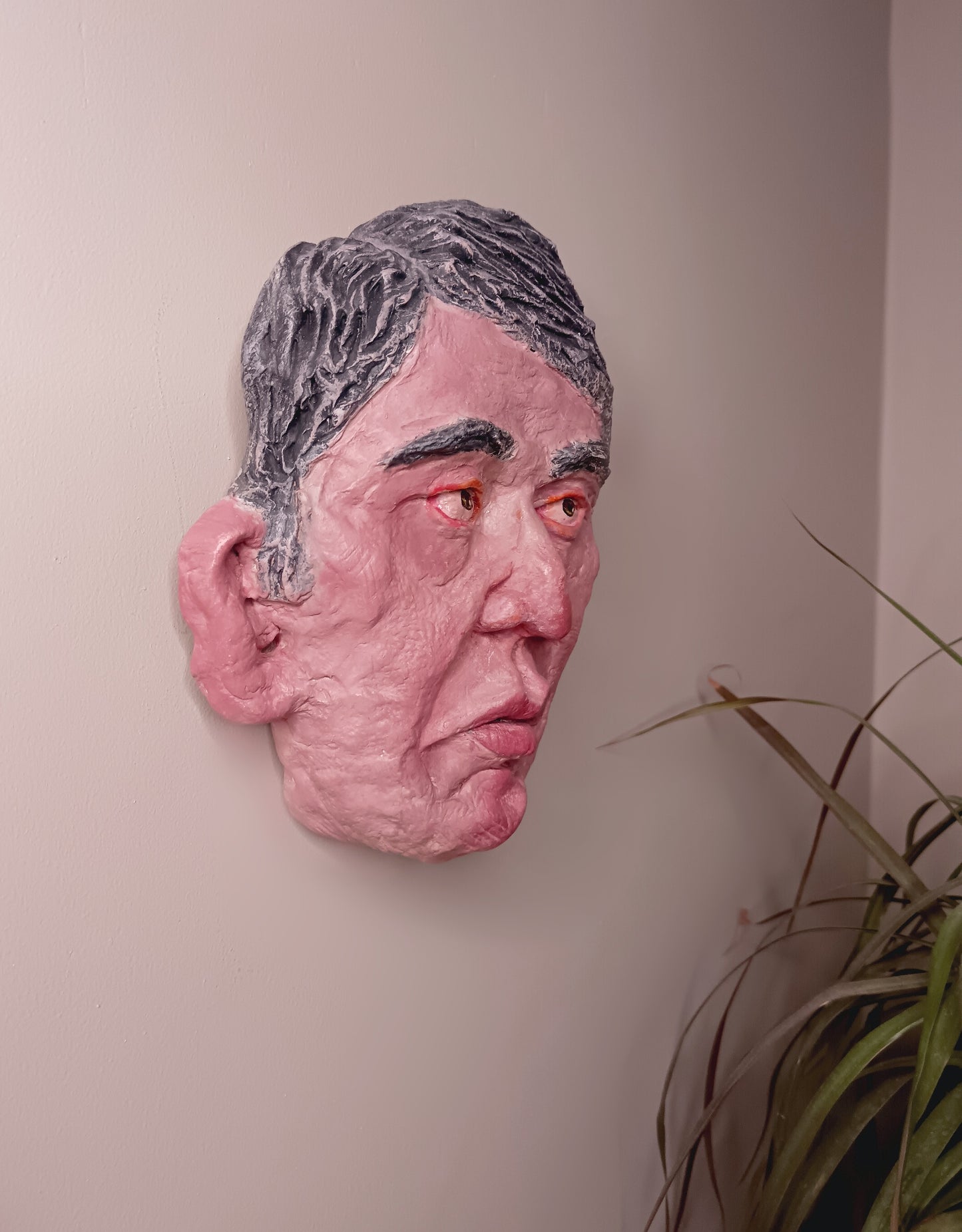 male clay sculpture wall hanging side