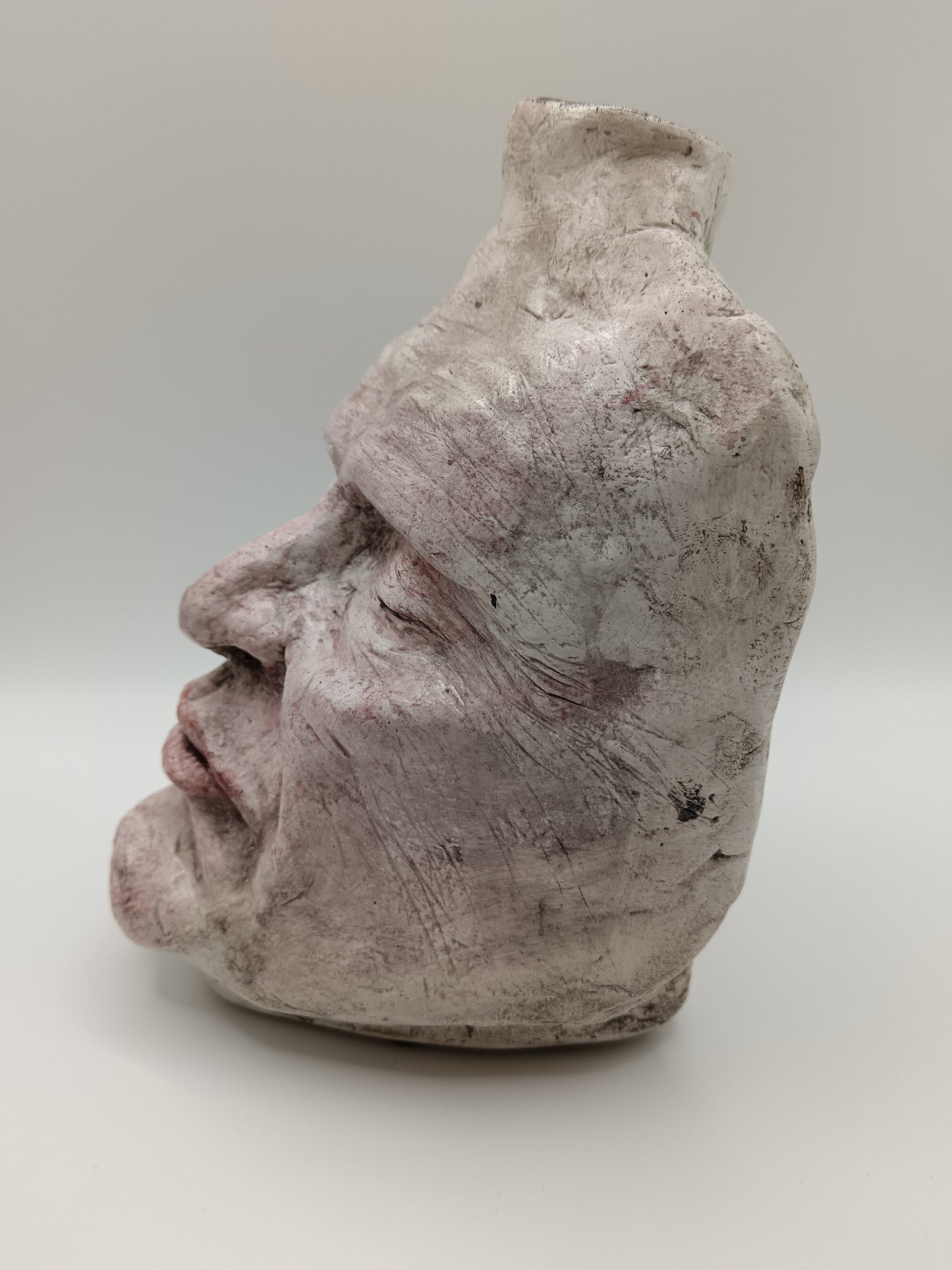 Airy dry clay vase - male face, left side