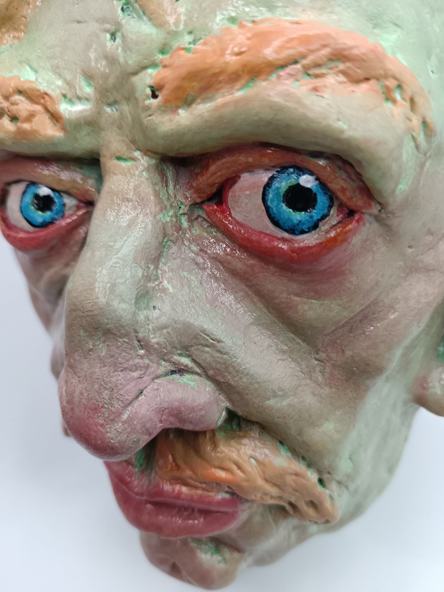 Hand sculpted green man sculpture close-up