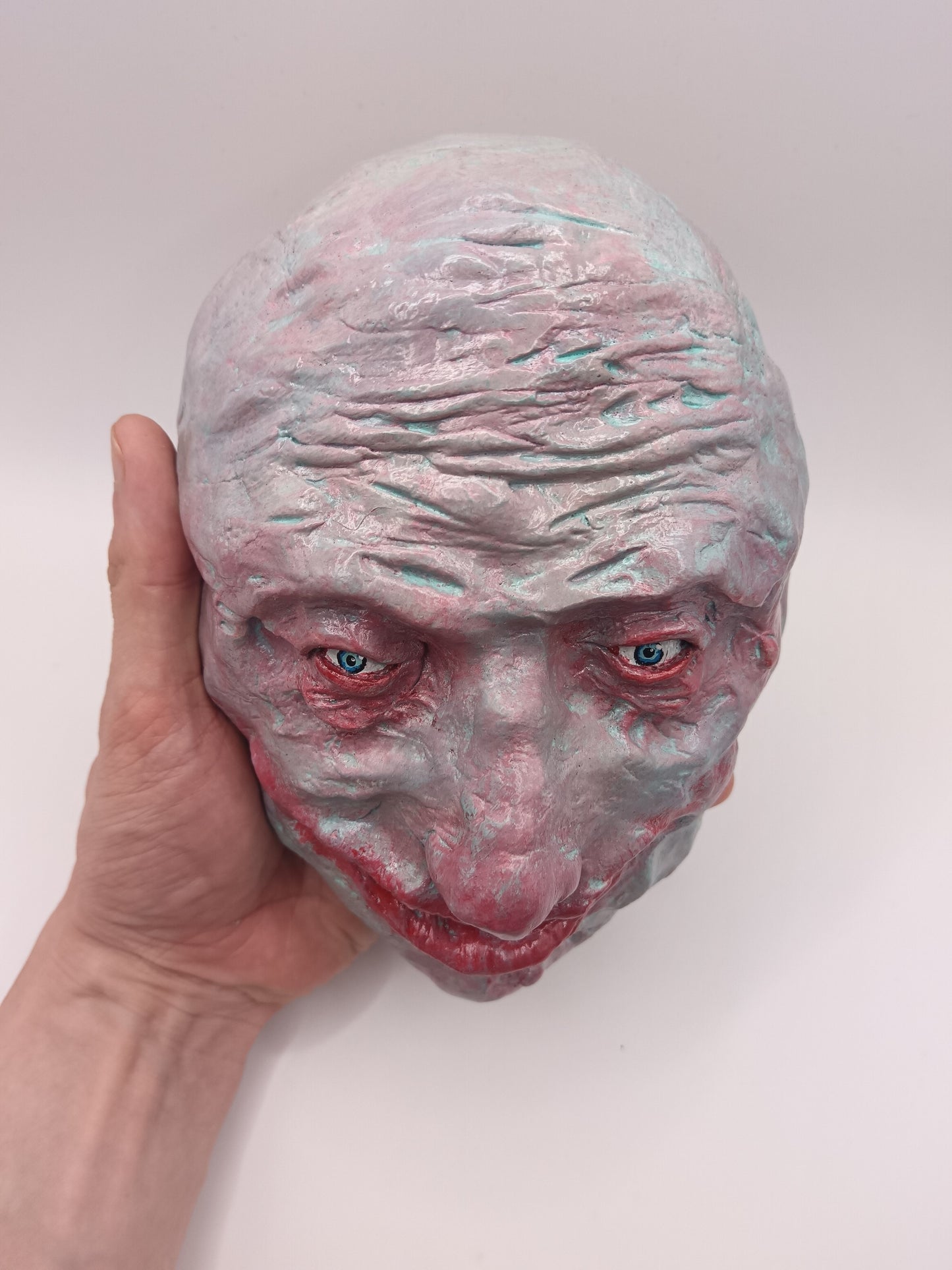 creepy grinning hand sculptured horror sculpture top view