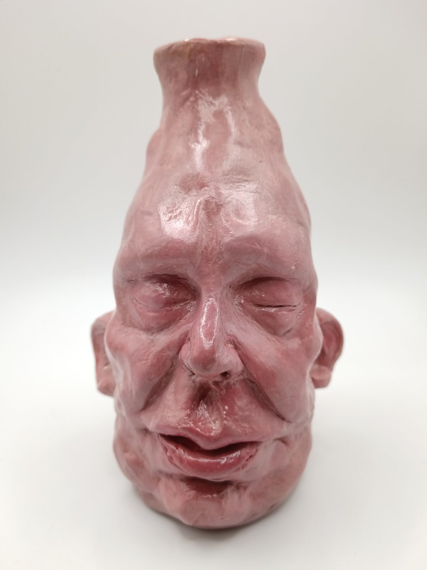 handmade closed-eye clay face vase, front view