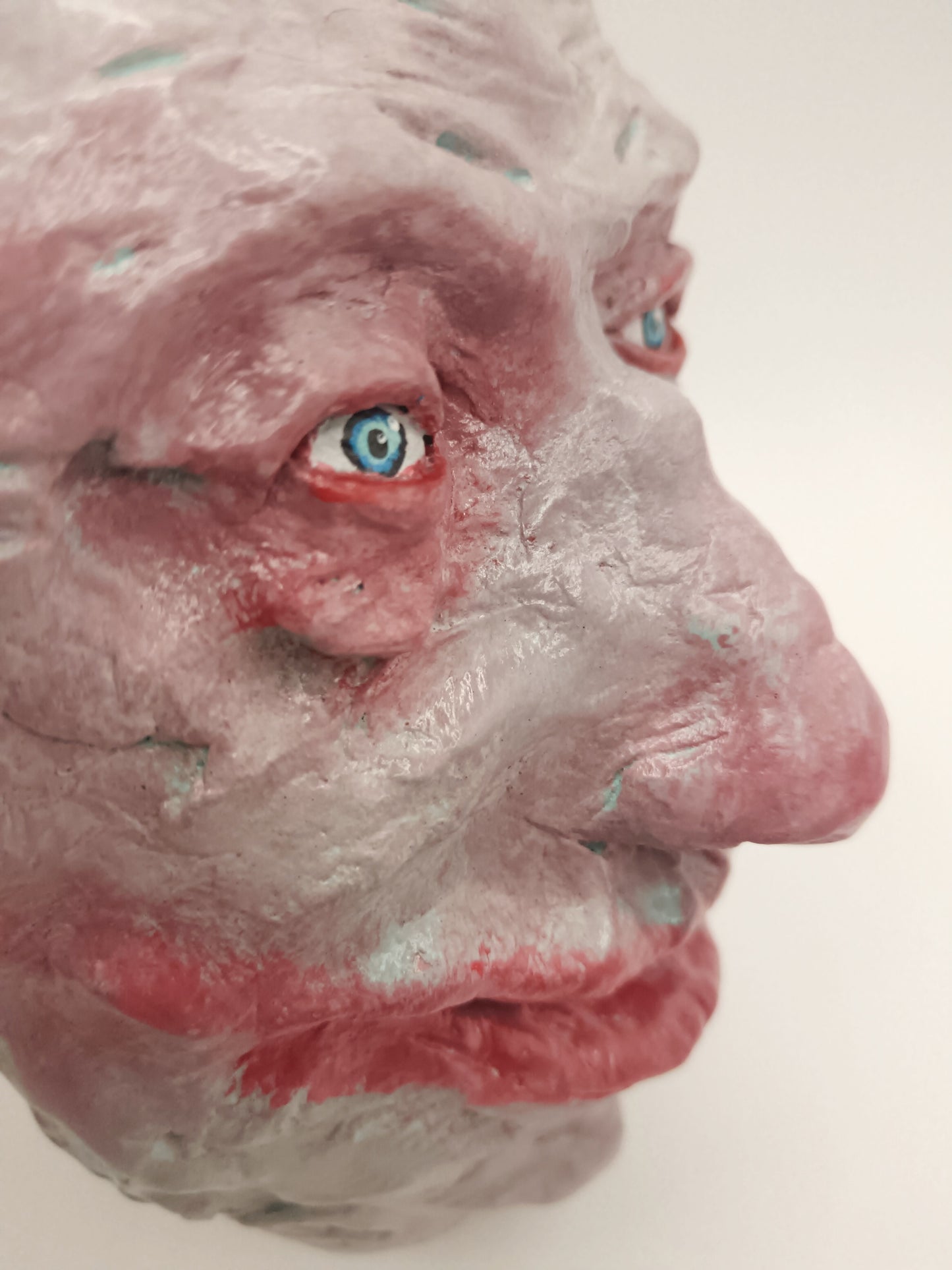 creepy grinning hand sculptured horror sculpture close up