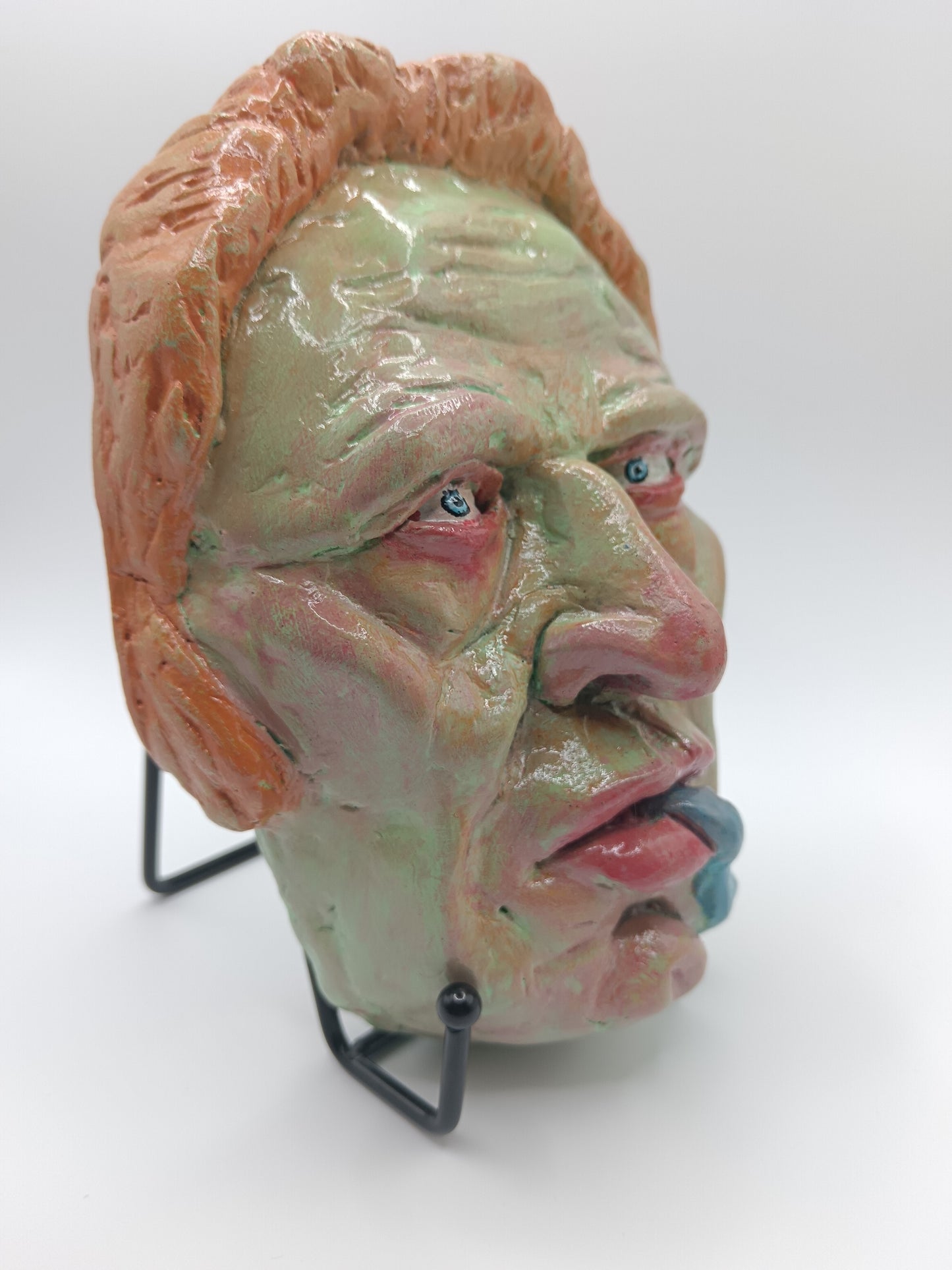 hand sculpted lizard man clay sculpture with stand front right