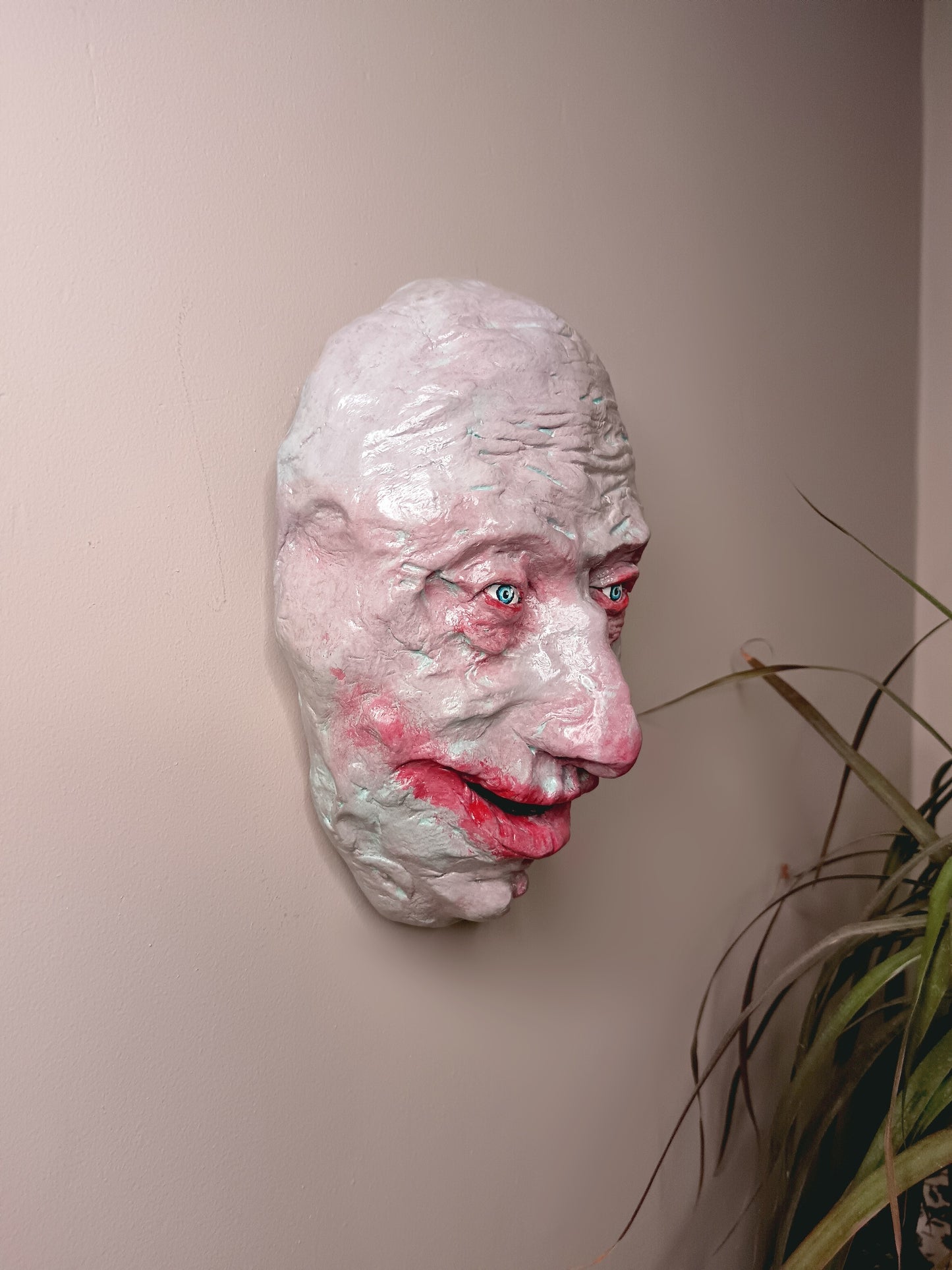 creepy grinning hand sculptured horror sculpture wall hanging side