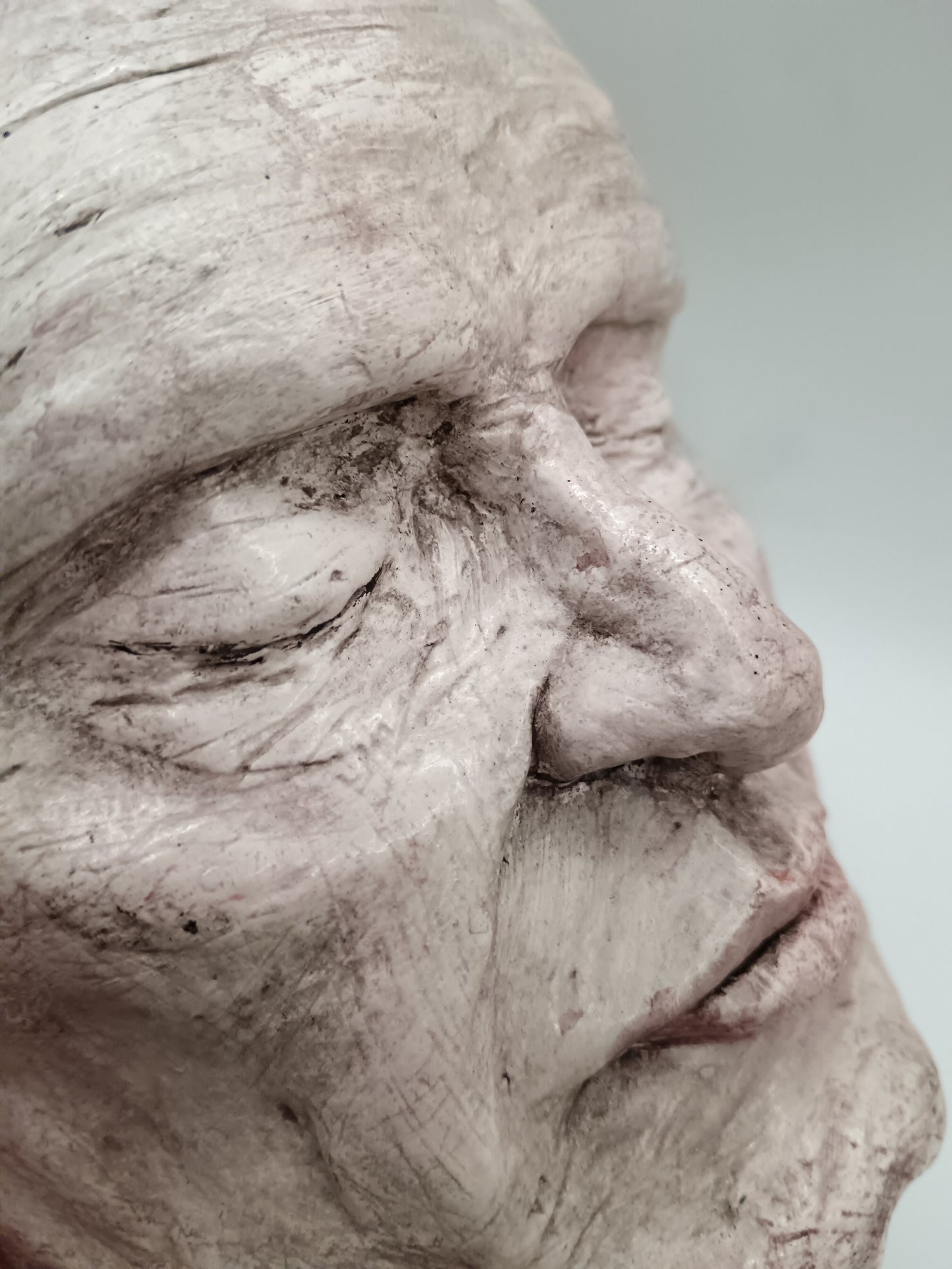 Airy dry clay vase - male face, close-up