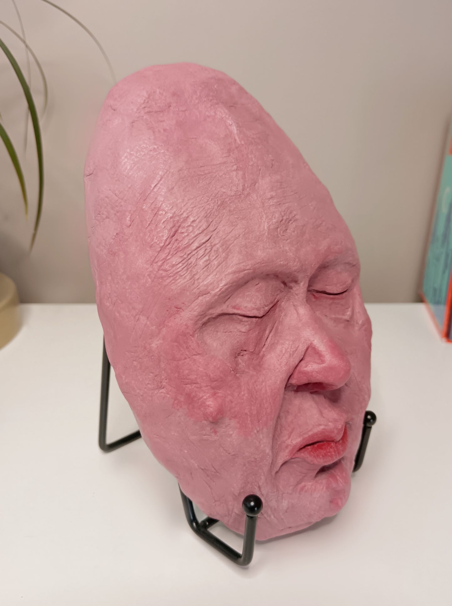 hand sculpted egghead sculpture, home setting side view