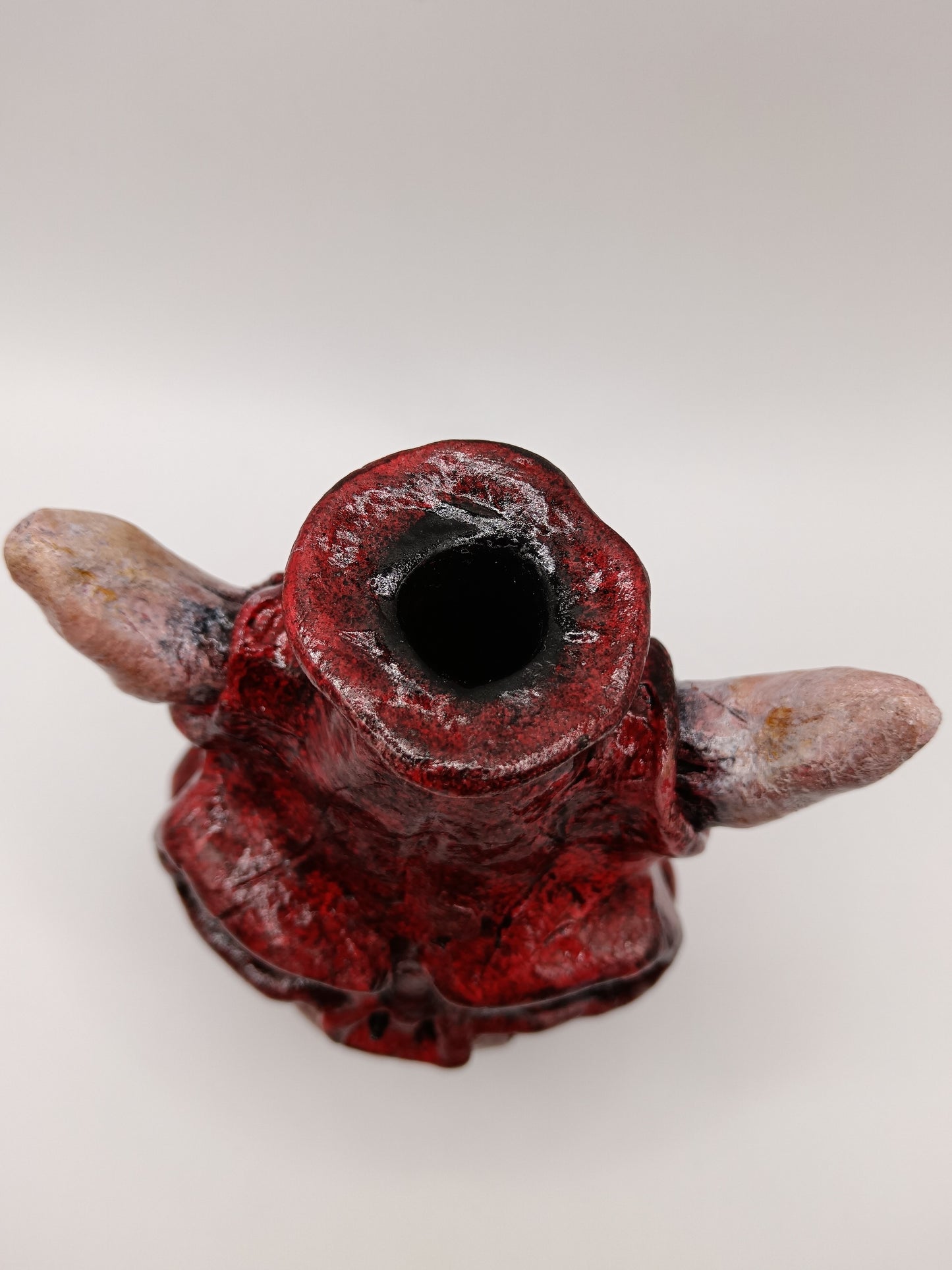 Hand made clay red skull vase with horns top