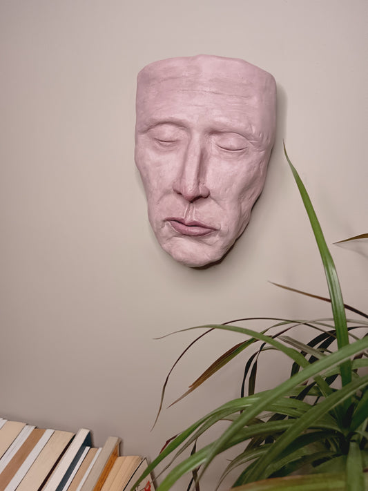 hand sculpted death mask sculpture wall hanging, home setting