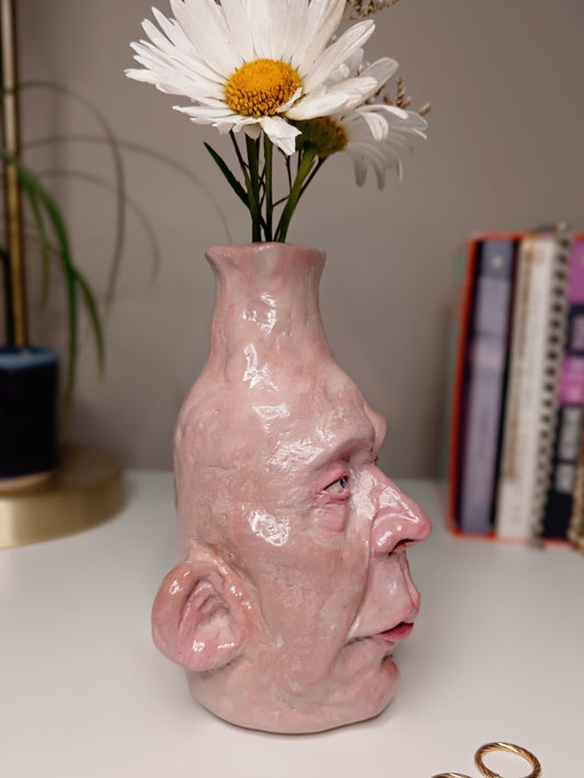 handmade realistic face vase, home setting side view