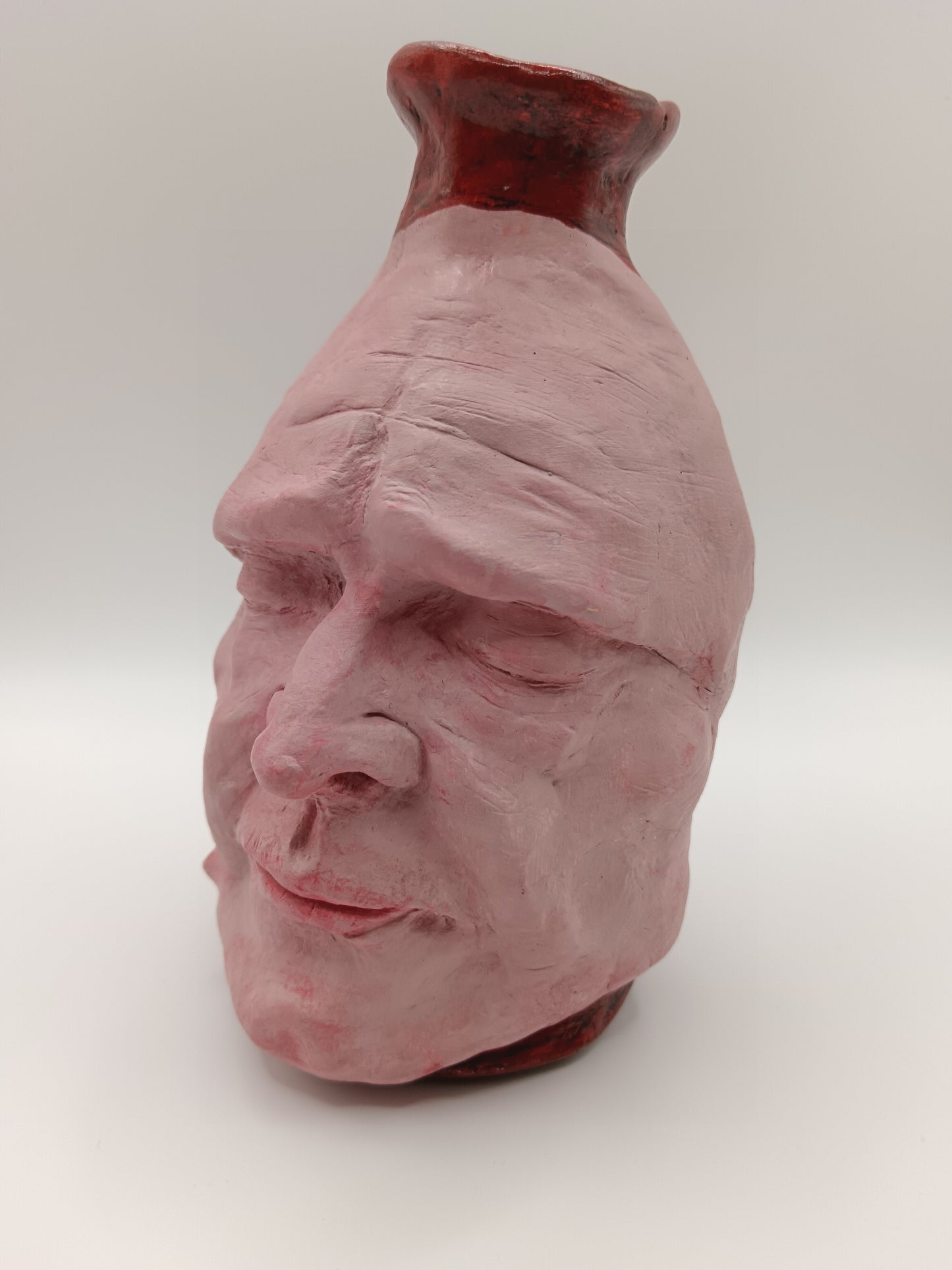 Handmade clay death mask vase, front left