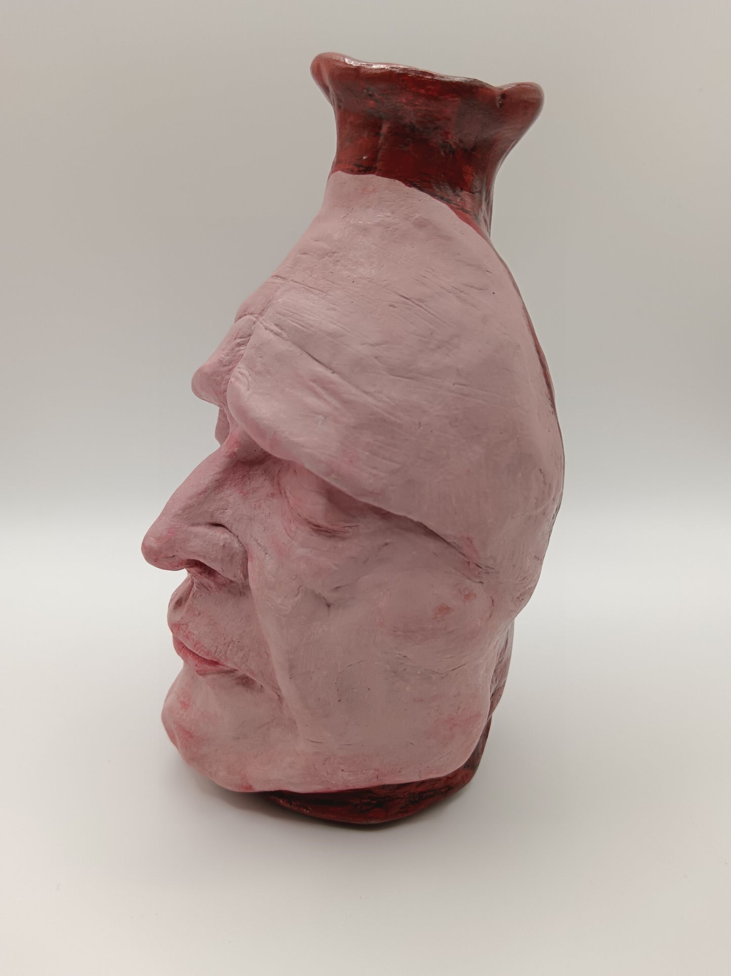 Handmade clay death mask vase, left side