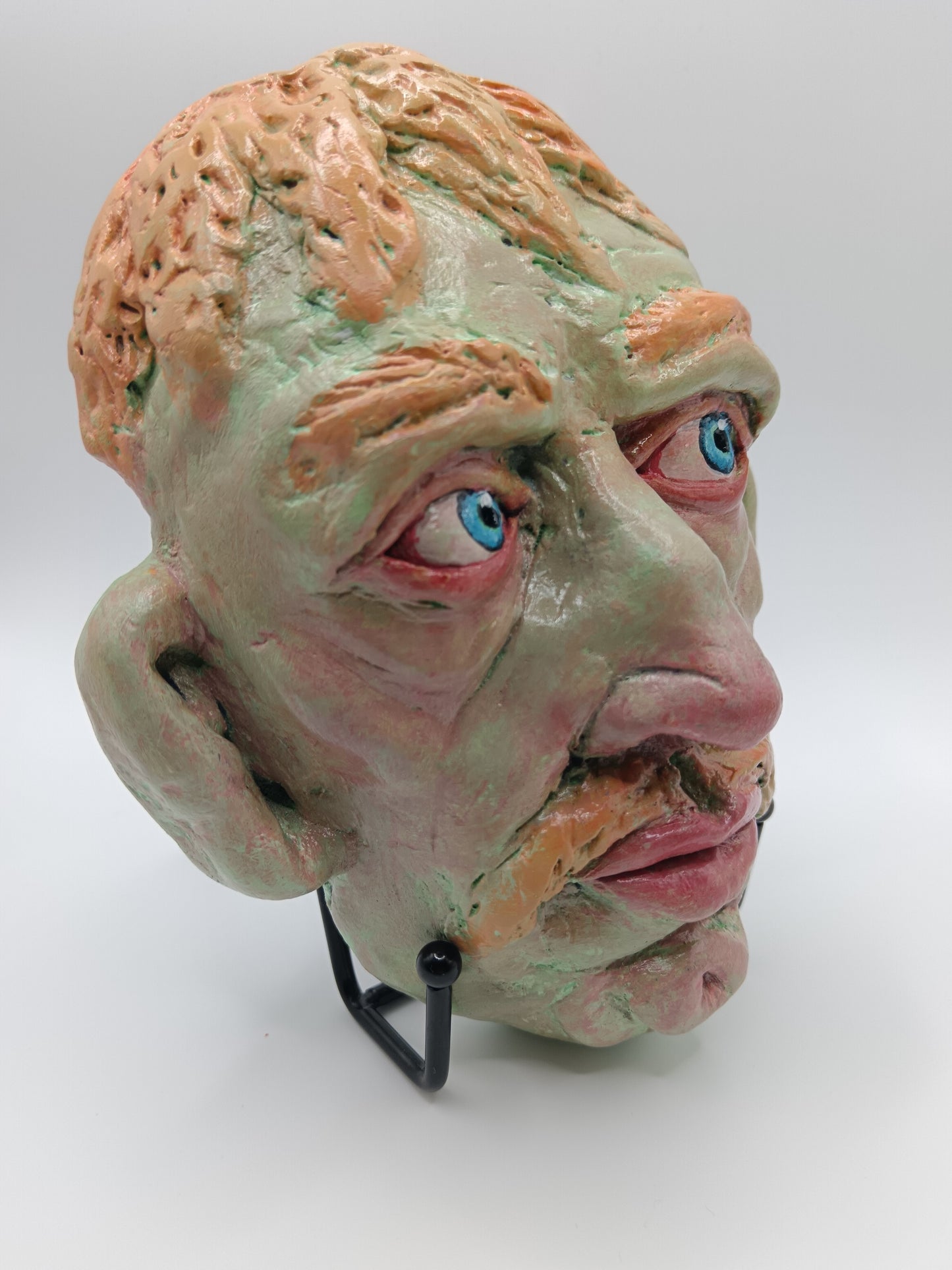 Hand sculpted green man sculpture with stand, front right