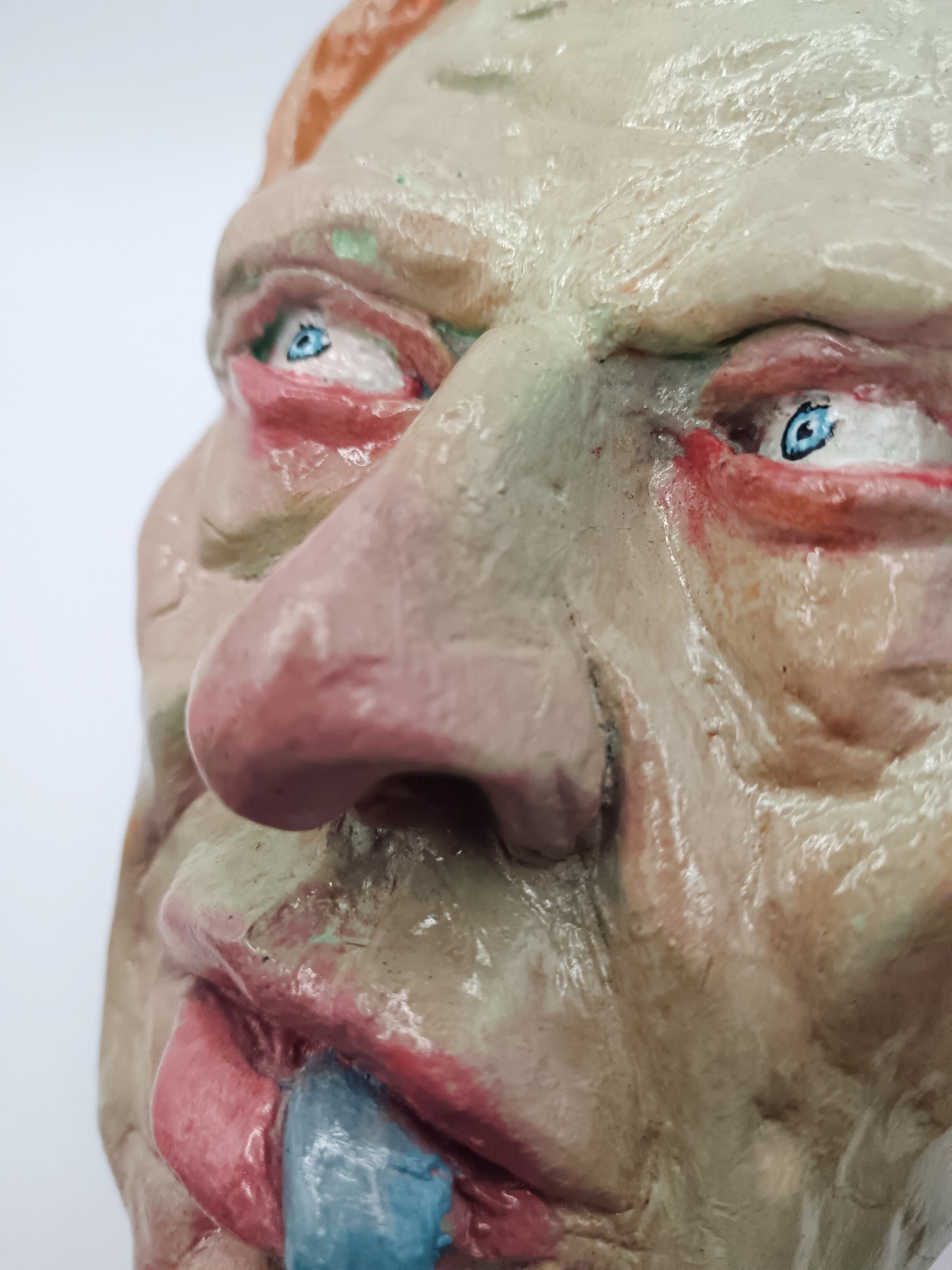 hand sculpted lizard man clay sculpture close up