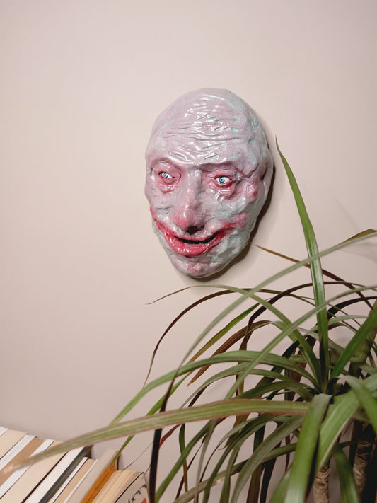 creepy grinning hand sculptured horror sculpture wall mounted