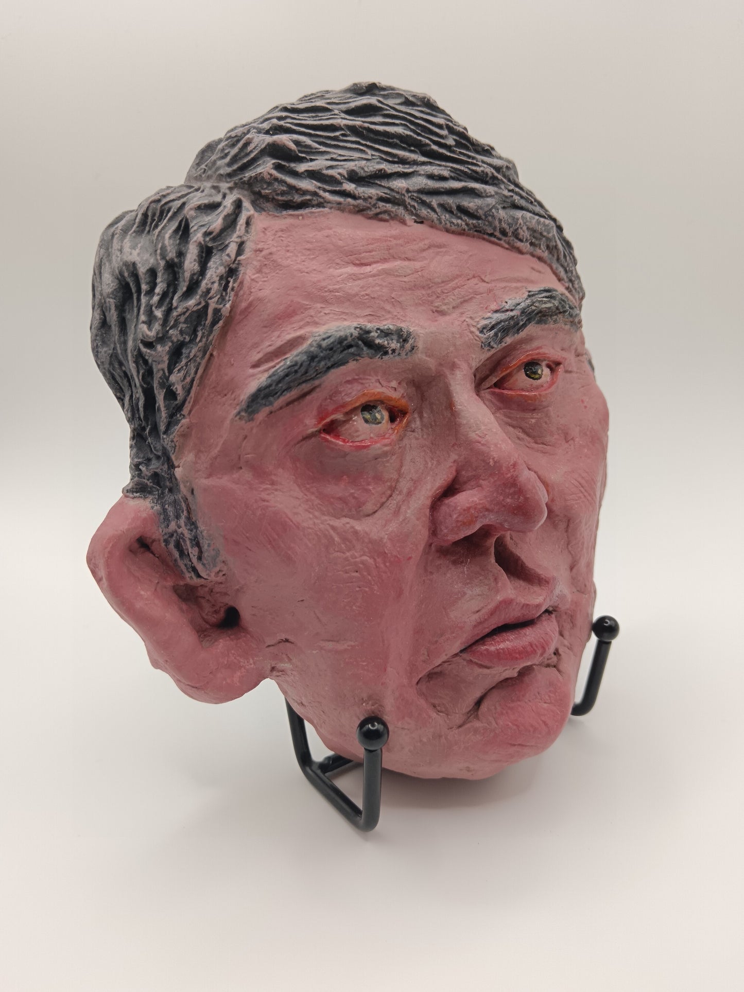 male clay sculpture with stand front right view