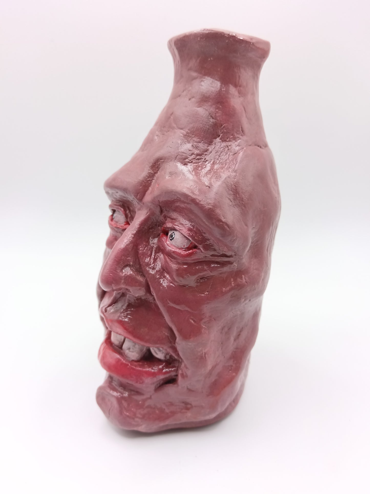 Handmade caricature face vase, left view