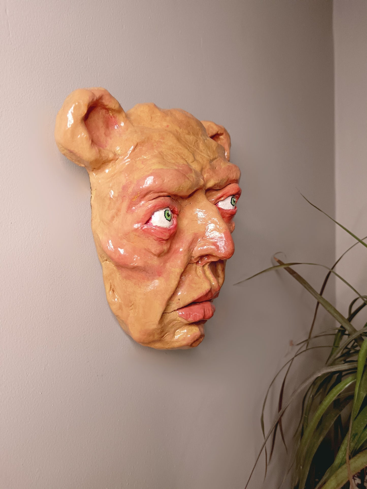creepy yellow bear, hand sculpted clay sculpture mask wall mounted, side
