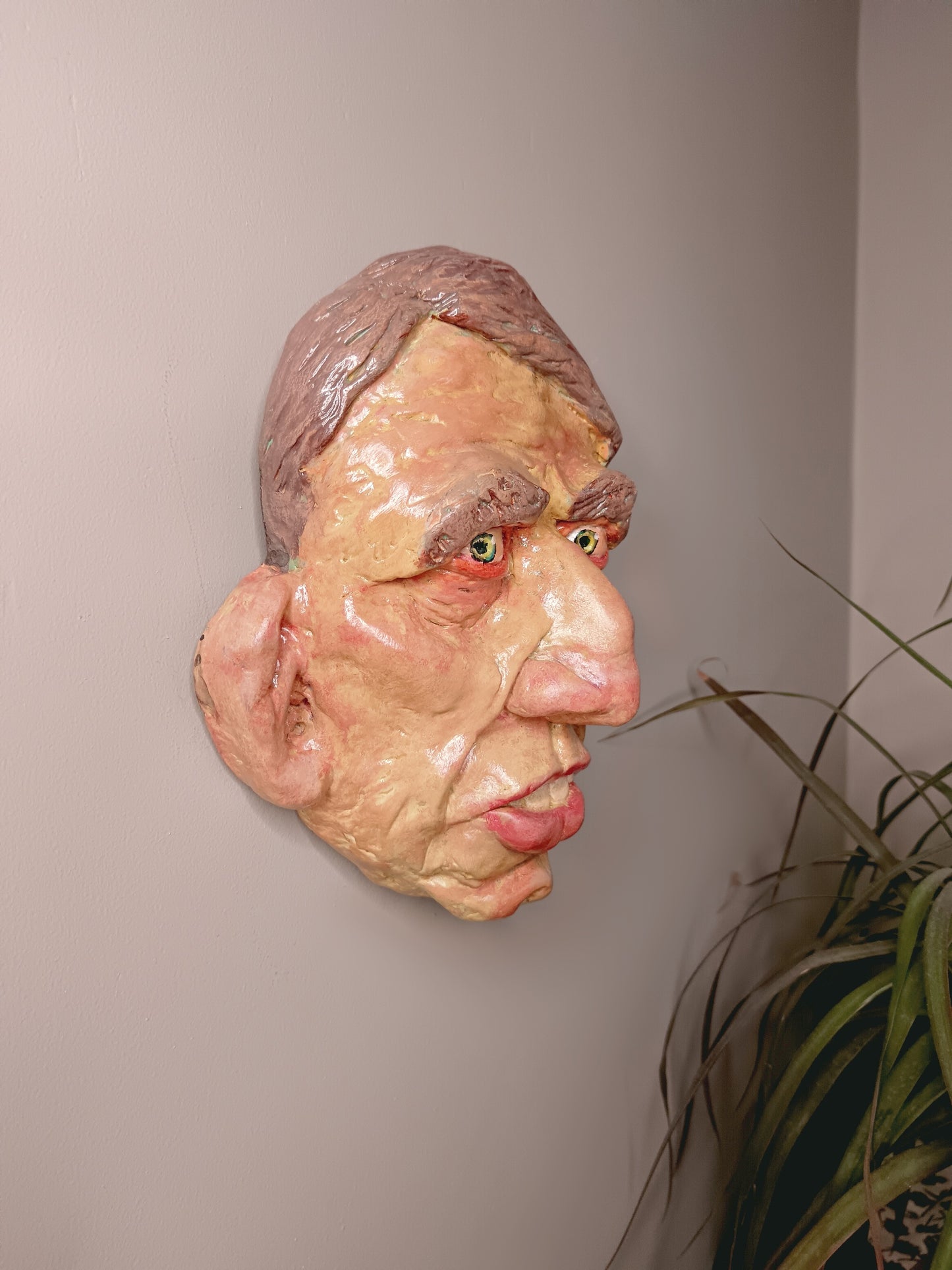 Hand sculpted clay yellow face mask sculpture wall hanging