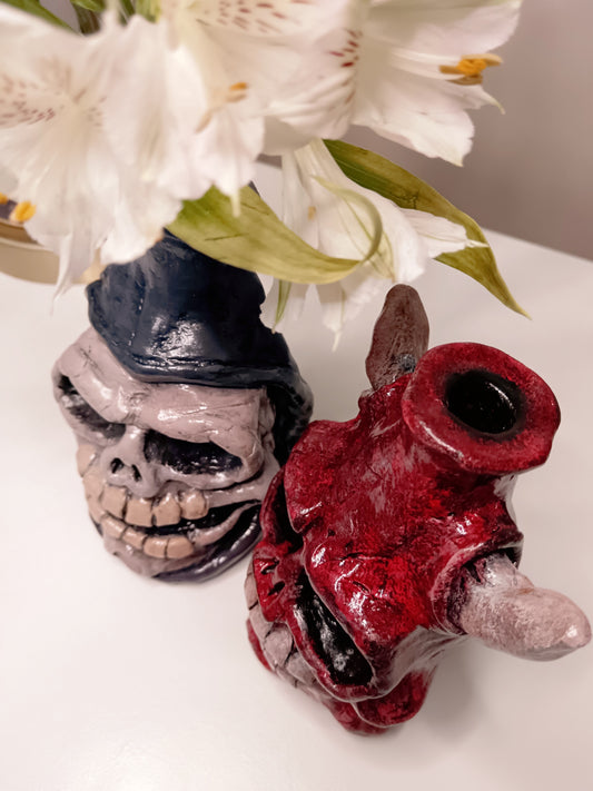 Two unique vases shaped like a skull .