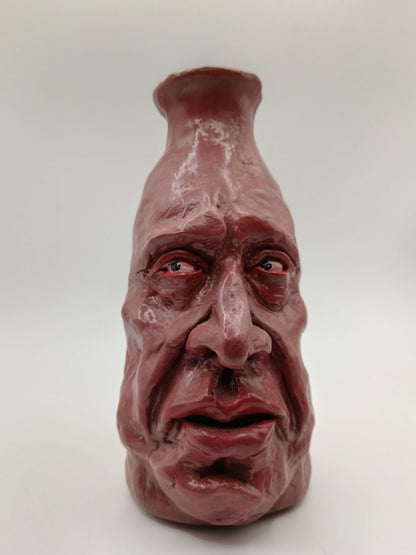 hand sculpted clay vase with face