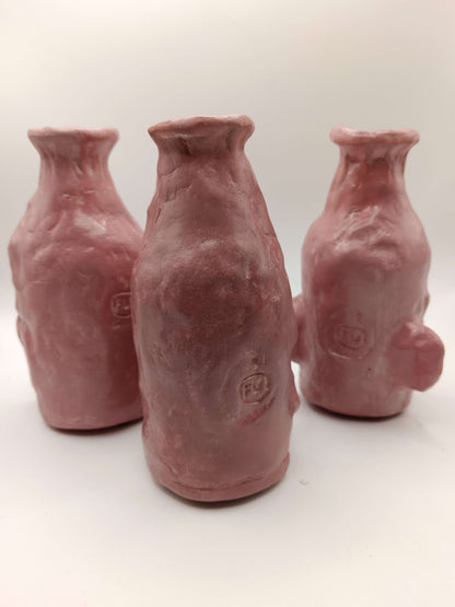 Three ceramic bottles with a textured surface on a white background