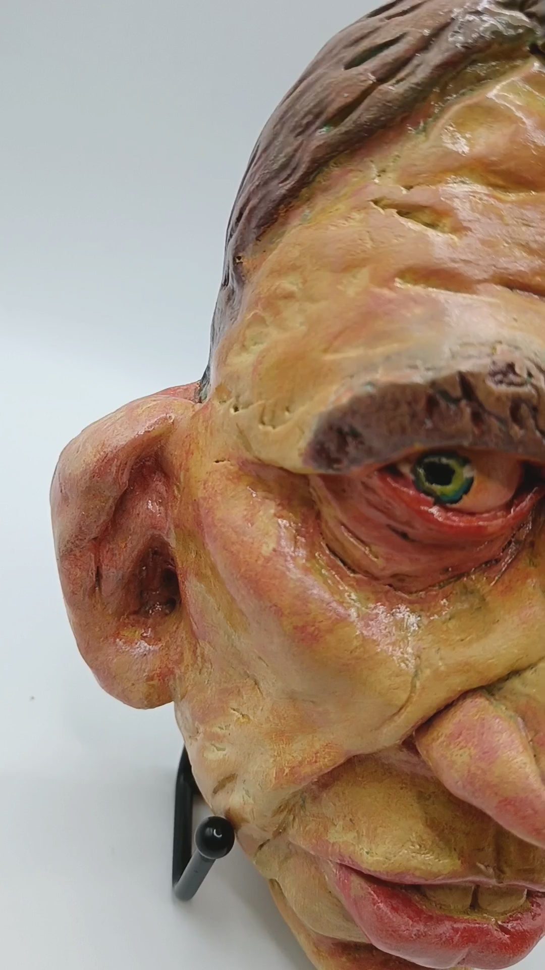 Hand sculpted clay yellow face mask sculpture lightbox video