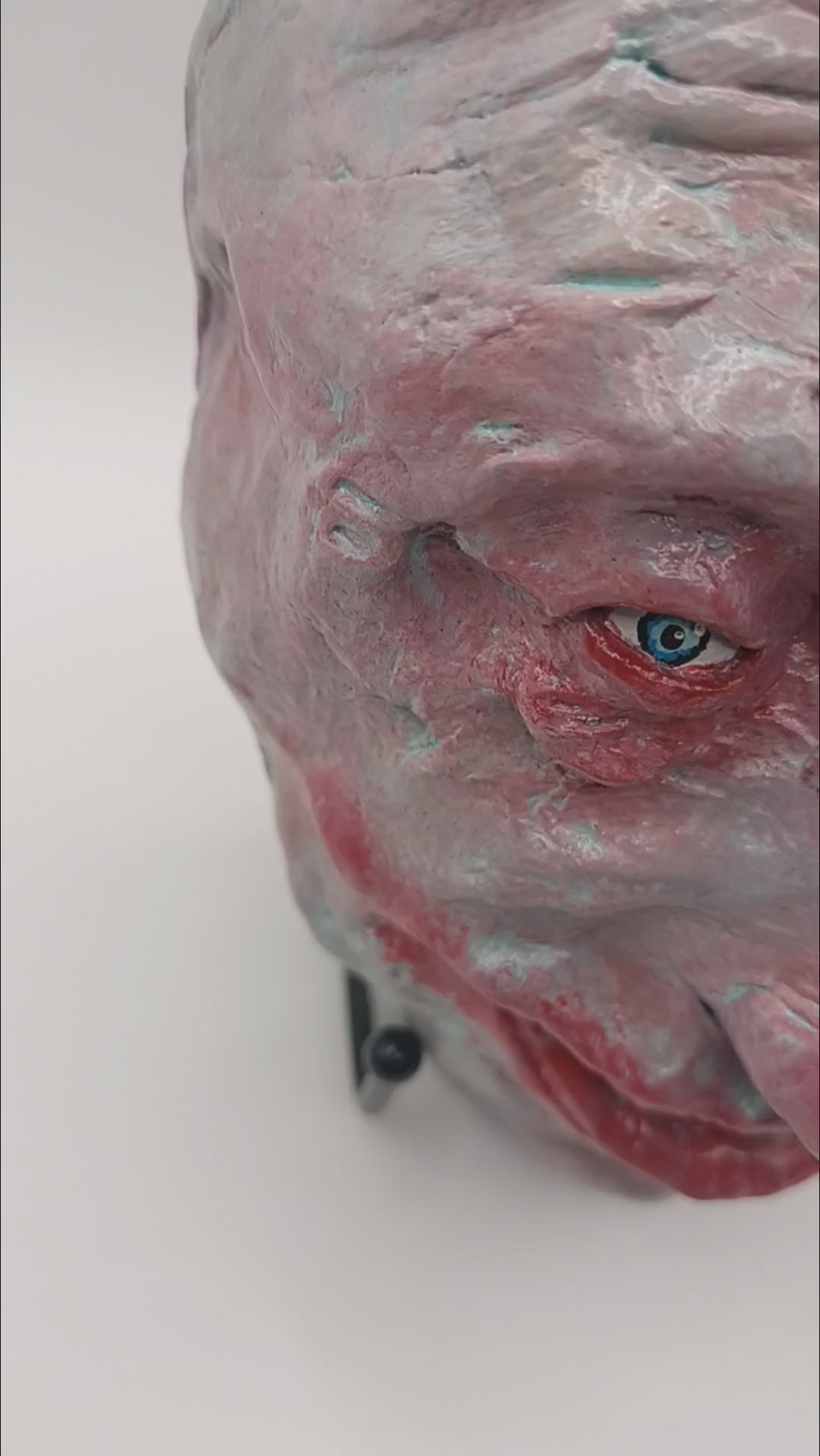  creepy grinning hand sculptured horror sculpture lightbox video