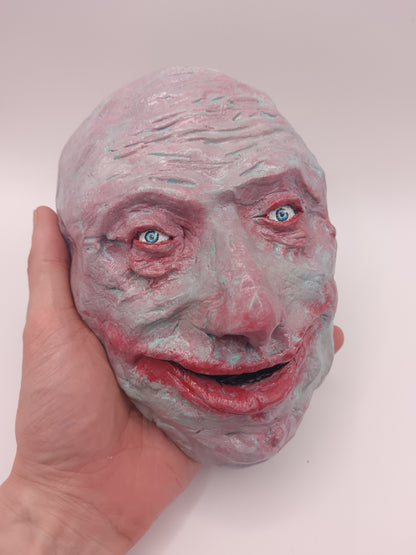  creepy grinning hand sculptured horror sculpture 