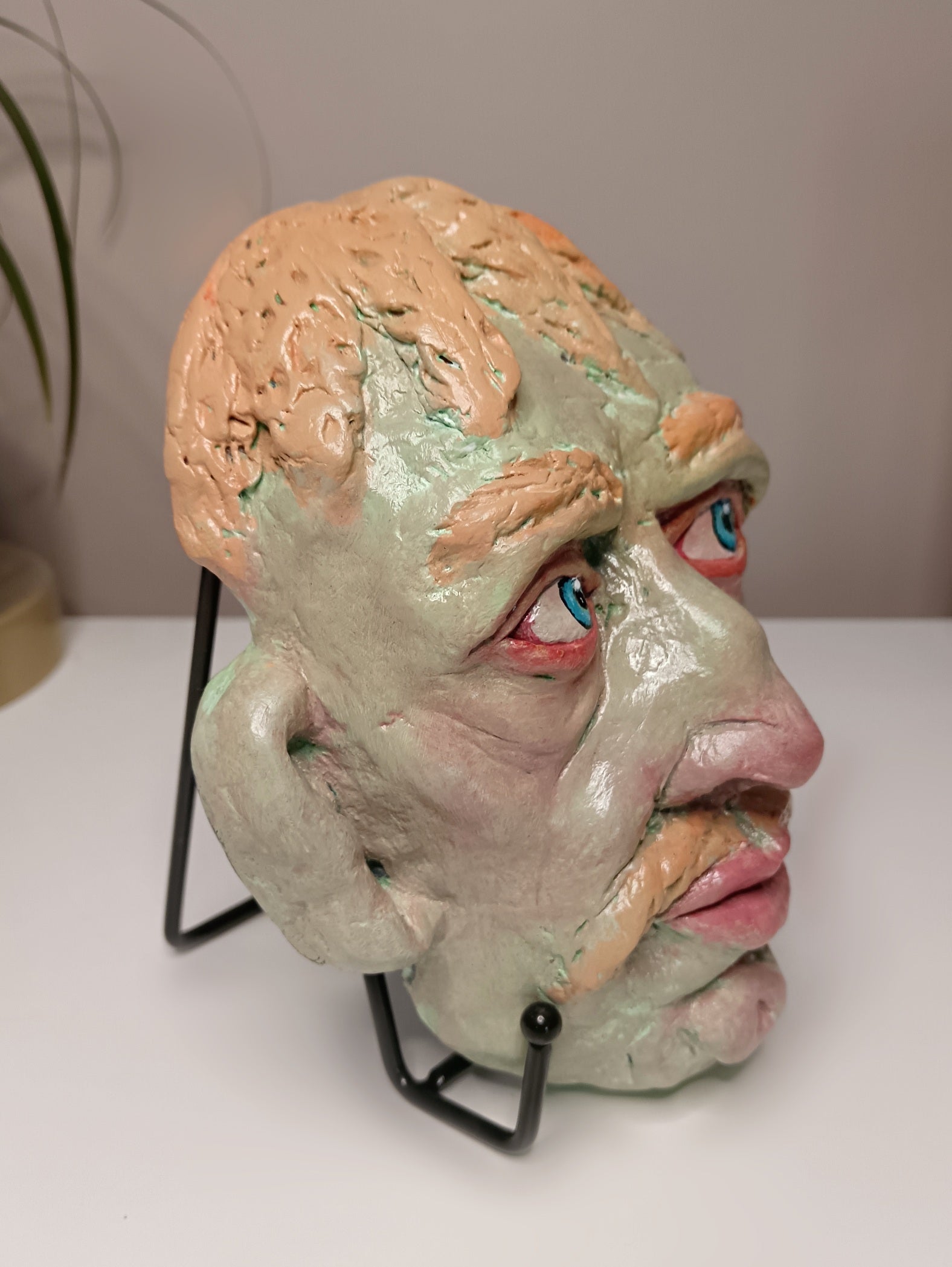 Hand sculpted green man sculpture side view