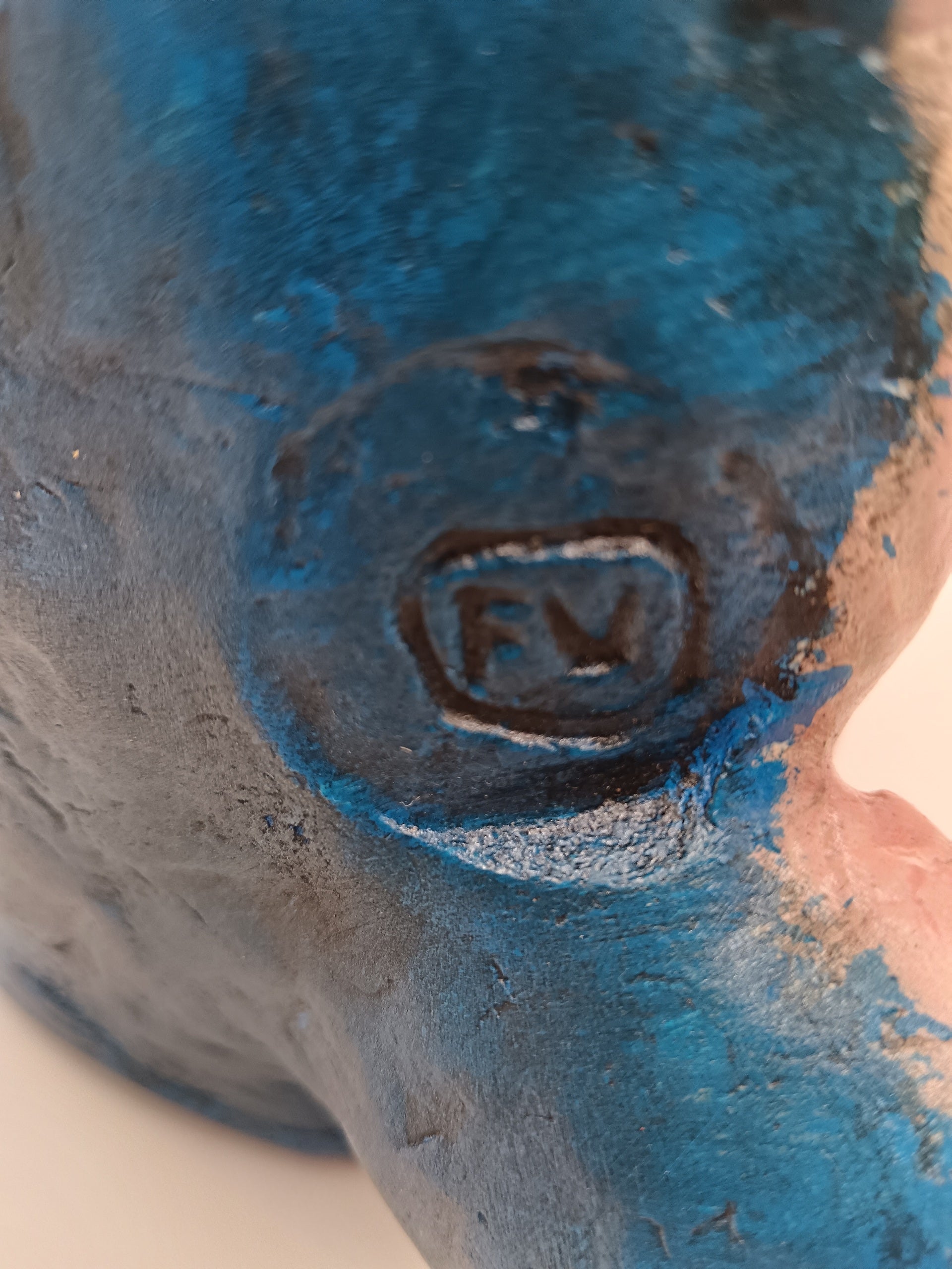Close-up of a signature on a textured blue surface