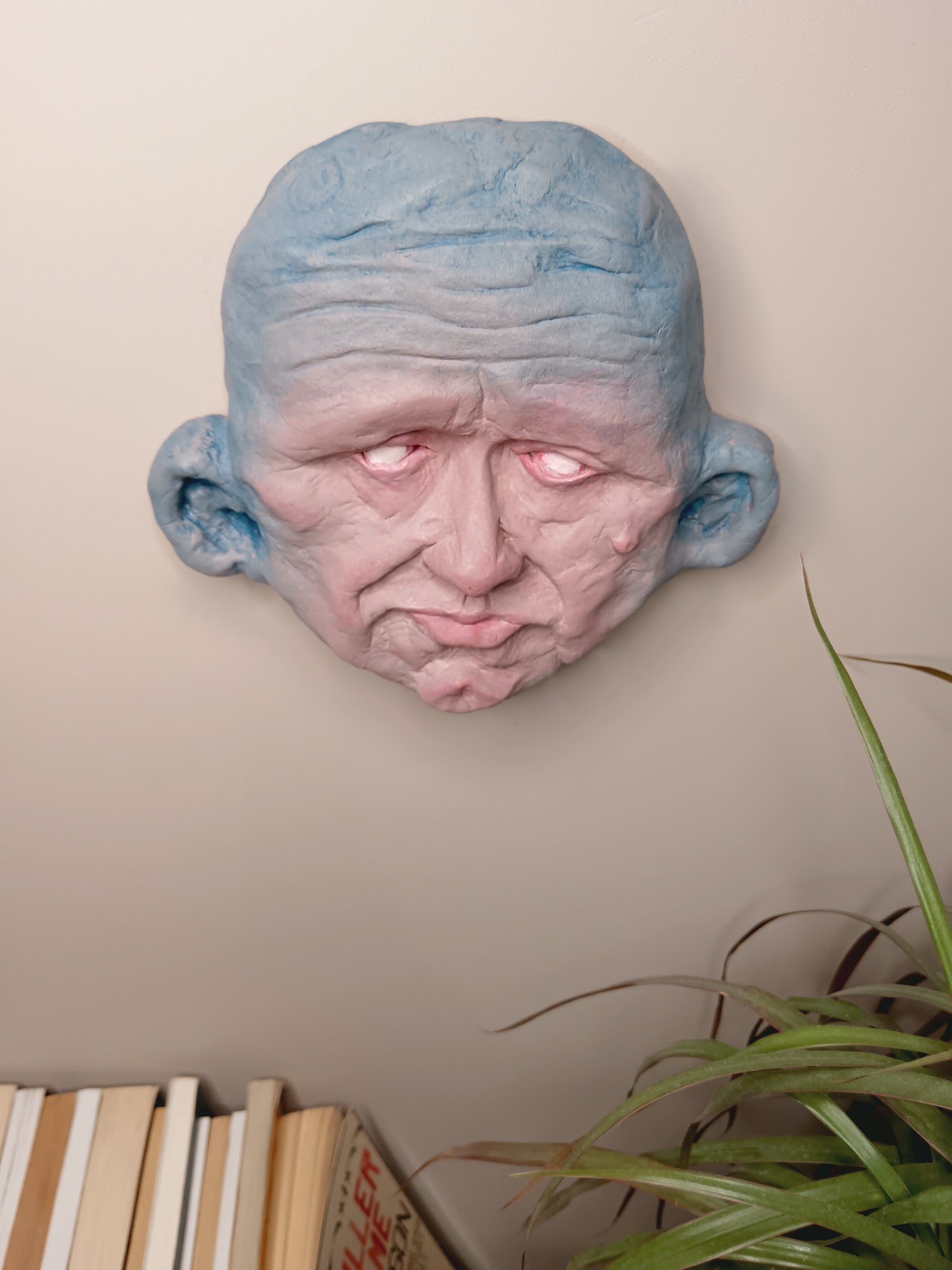Blue face Handmade sculpture on wall mounted top