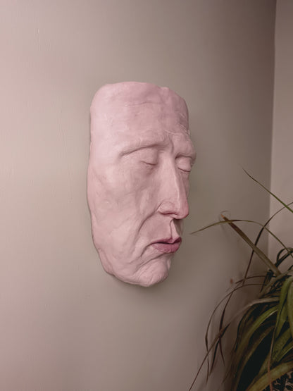 hand sculpted death mask sculpture wall mounted, side view 
