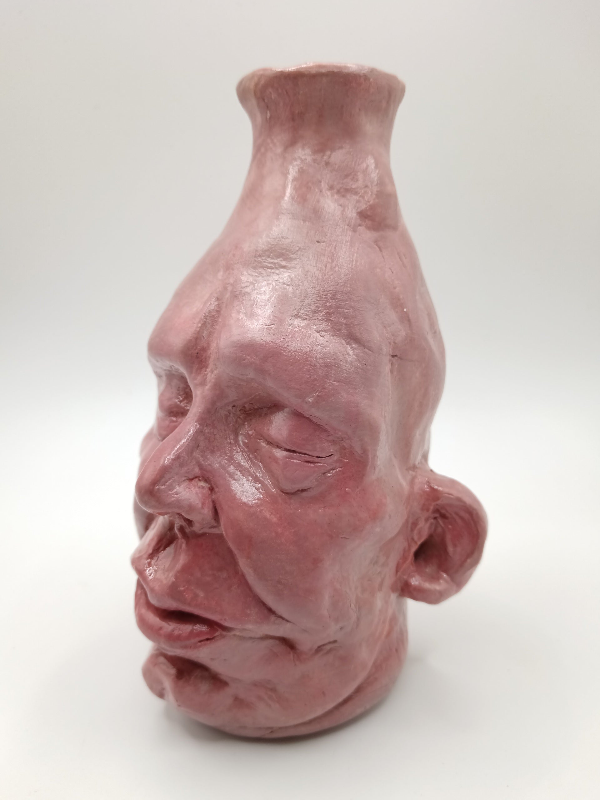 handmade closed-eye clay face vase, left view
