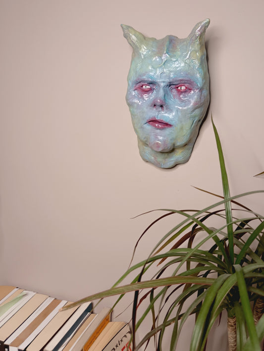 Hand sculpted clay pastel demon sculpture wall mounted 