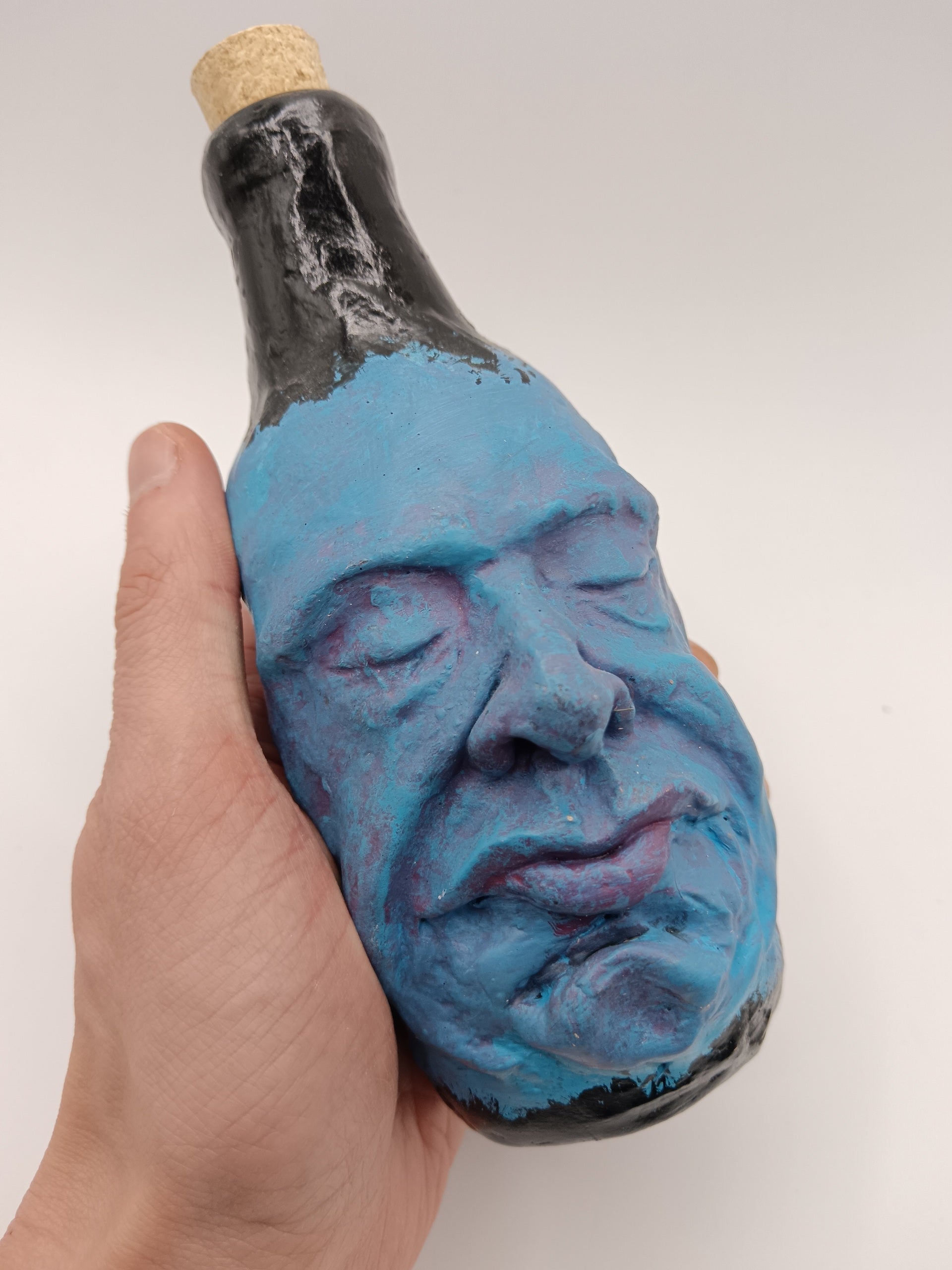 blue handmade portrait bottle vase in hand